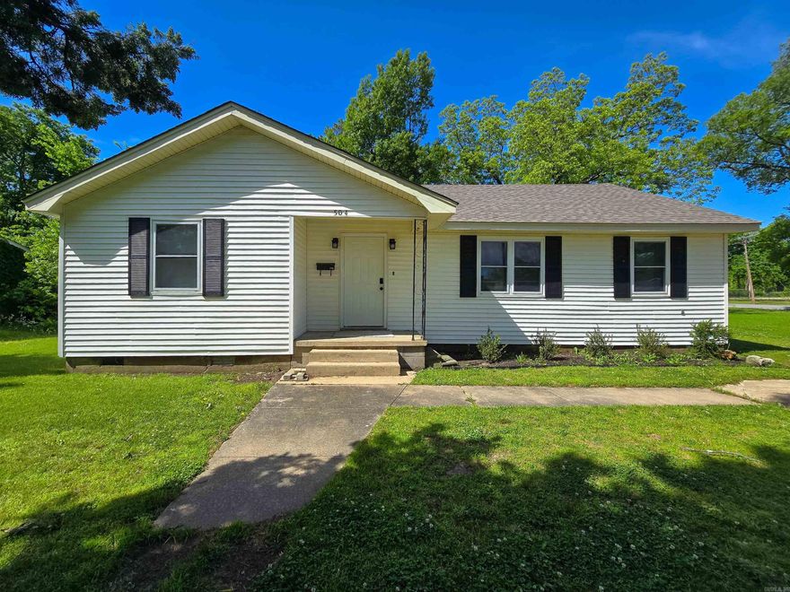 This charming 3-bedroom, 1-bath home is cute as can be and ideally located just across the street from the high school and only a few blocks from the elementary school. Recently refreshed, the home features new paint, updated light fixtures and ceiling fans, new carpet, a brand-new cook stove, and an updated bathroom with a new vanity and fixtures. Situated on a .26± acre tree-shaded lot, the property offers a peaceful outdoor setting. A 14x16 utility building with electricity in the backyard adds valuable storage or workspace. This move-in ready home combines comfort, convenience, and updates—all in a great location. *Owner has Active Arkansas Real Estate license.