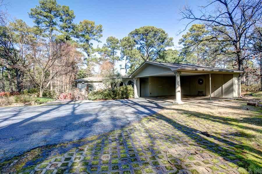 "Villa Contente"...a special one of a kind property sitting on over 5 acres with lake in the heart of West Little Rock. Original Home was designed with an Italian flair as a "country getaway". Home has recently undergone extensive renovations and additions from the original structure. Kitchen/Dining Room was completely gutted and renovated with top notch of everything in 2013. 3 New HVAC systems in 2013. Master on main level with guest suite. Lot topography & extensive landscaping provide privacy.