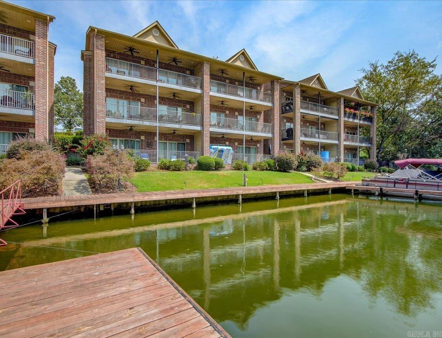 PERFECT LAKESIDE RETREAT IN THE HEART OF HOT SPRINGS! This stunning 2-bed, 2.5-bath condo, nestled in the desirable Lakeland Bay subdivision, offers a seamless blend of comfort and luxury. Built in 2006 and meticulously maintained, you’ll be greeted by the rich warmth of dark wood cabinets & upscale fixtures throughout. Step into the modern kitchen with sleek stainless steel appliances & large tile floors that flow into the dining & living areas, creating a spacious & inviting atmosphere. But the real showstopper? The stunning lake views from your private deck! Imagine sipping your morning coffee with serene water views, taking a dip from the dock, or enjoying a swim just steps away. When it’s time to entertain, the condo’s amenities won’t disappoint—a covered, upscale picnic area complete with grills and a fireplace is perfect for gatherings, rain or shine. Majority of the furniture will stay. See Agent Remarks for exclusions. Utility bills are LOW. The Universal dock is available for owners to tie up their boats for a weekend, possibly longer.  Agents - Call Showing service to schedule all showings.
