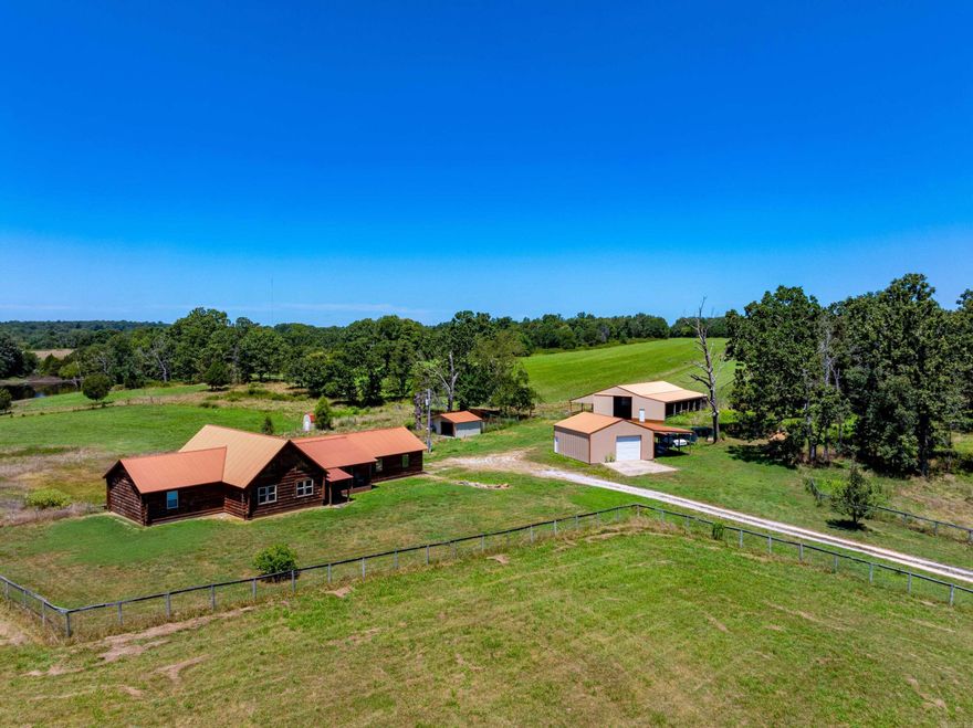 Legacy Ranch Estate – Custom Log Home on 116.92± Acres in the Ozarks 4 Bed | 3.5 Bath | 4,560± Sq Ft | $998,500 Secluded • Scenic • Self-Sustaining  Welcome to one of the most impressive rural estates in the Ozarks—this custom-built 4-bedroom, 3.5-bath log home sits on 116.92± acres of premium cattle-ready pasture and recreational land, offering the perfect blend of comfort, functionality, and scenic beauty.  Built in 2009, the home features 4,560± sq ft of finished living space, including a 2,400± sq ft main level and a 2,160± sq ft walk-out basement. Highlights include 18-ft vaulted ceilings, a dramatic stone fireplace, gourmet kitchen with new stainless appliances, dedicated office, oversized 2-car garage, and a screened-in porch with breathtaking sunrise and sunset views.  The walk-out basement is ideal for a guest suite, in-law quarters, game room, or home theater, while the home is supported by central HVAC with propane backup, private well, storm shelter, and fiber internet (NEXT).  This is a working ranch, ready for livestock and full-scale agricultural production.