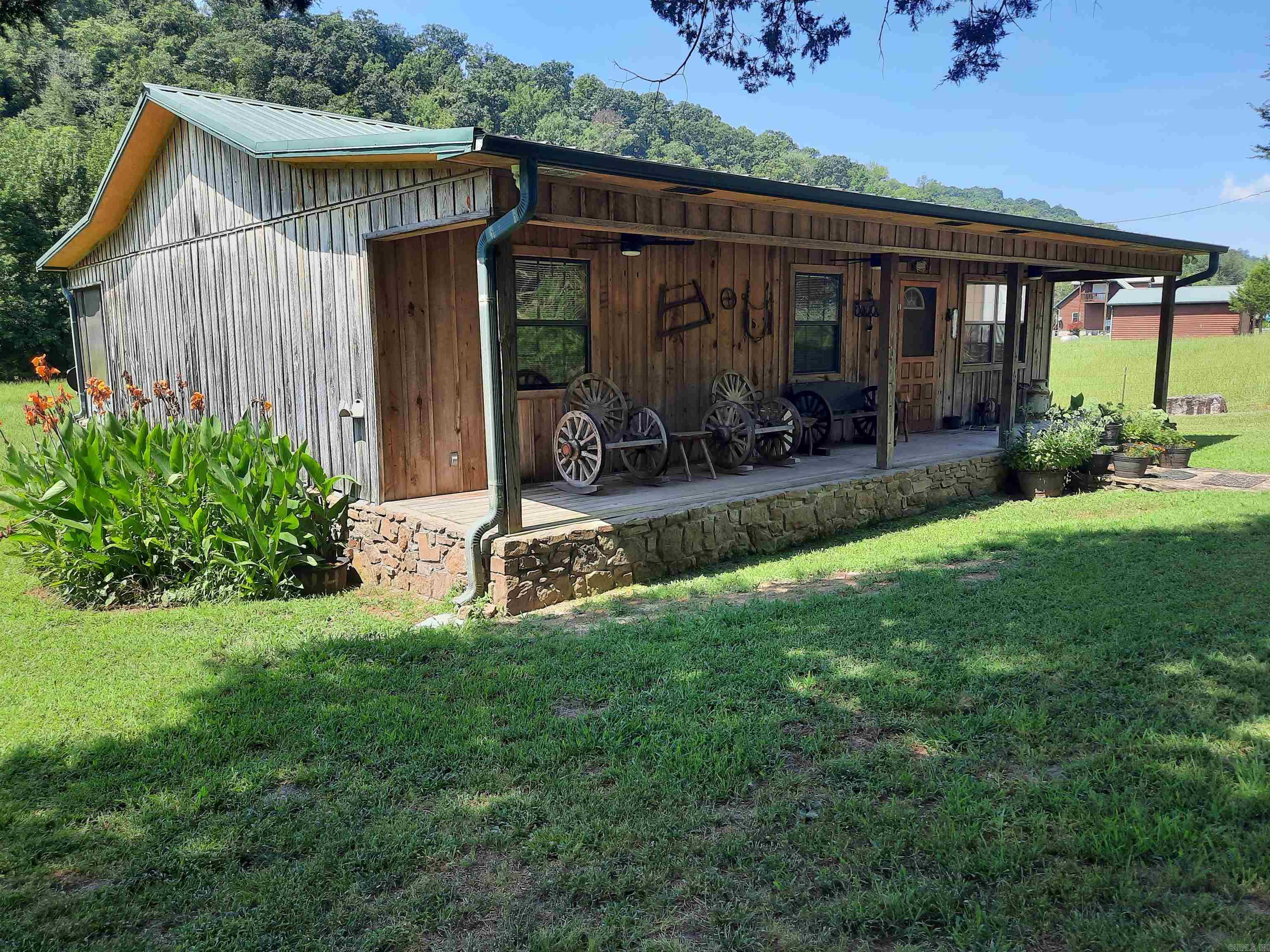 If you are looking for a move in ready get-away, with room for you and your horses, here is the perfect place. Very well maintained inside and out, 3 bedrooms, 2 bath, CH&A plus FP, large inviting front porch and large screened in back porch where you can sit and enjoy your morning coffee while watching the wildlife. Big barn with feed room, tack room, stalls, plus a detached tractor/implement barn, fenced and cross fenced. All this plus property boarders the Ozark National Forest, and a seasonal creek, with hundreds of acres to hike, ride and enjoy, and did I say a view! Sit and enjoy the beautiful views, in quiet and private setting. This and so much more, not many of these around, take a look.