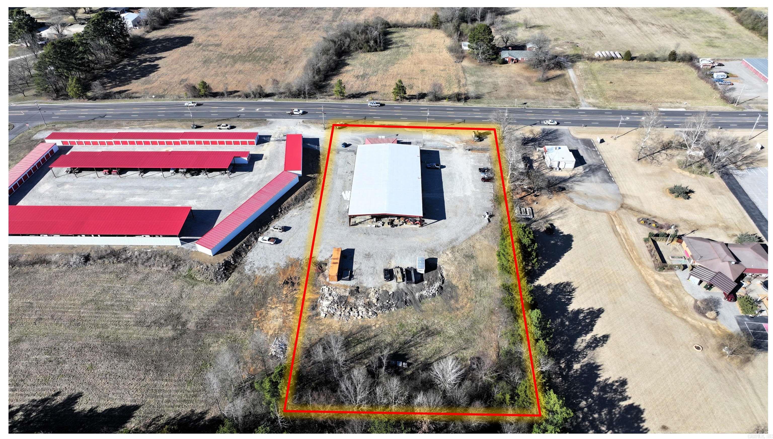 An exceptional investment opportunity with this expansive 16,000 sq ft commercial property located along Hwy 36 in Searcy. Dedicated pawn shop showroom with ample display and storage areas. Includes a spacious living quarters, and modern amenities, making it ideal for owner-operators or investors seeking rental income potential. Shop includes a 16ft high door clearance and 24ft shop clearance which is perfect for large equipment, deliveries, or storage needs. 2 full bathrooms and 3 half bathrooms for staff and customer convenience. 2 mop sinks for easy maintenance and cleaning. Office and conference rooms and private living space integrated into the property, offering a comfortable residence for the owner or manager. Agents see remarks for showing instructions.