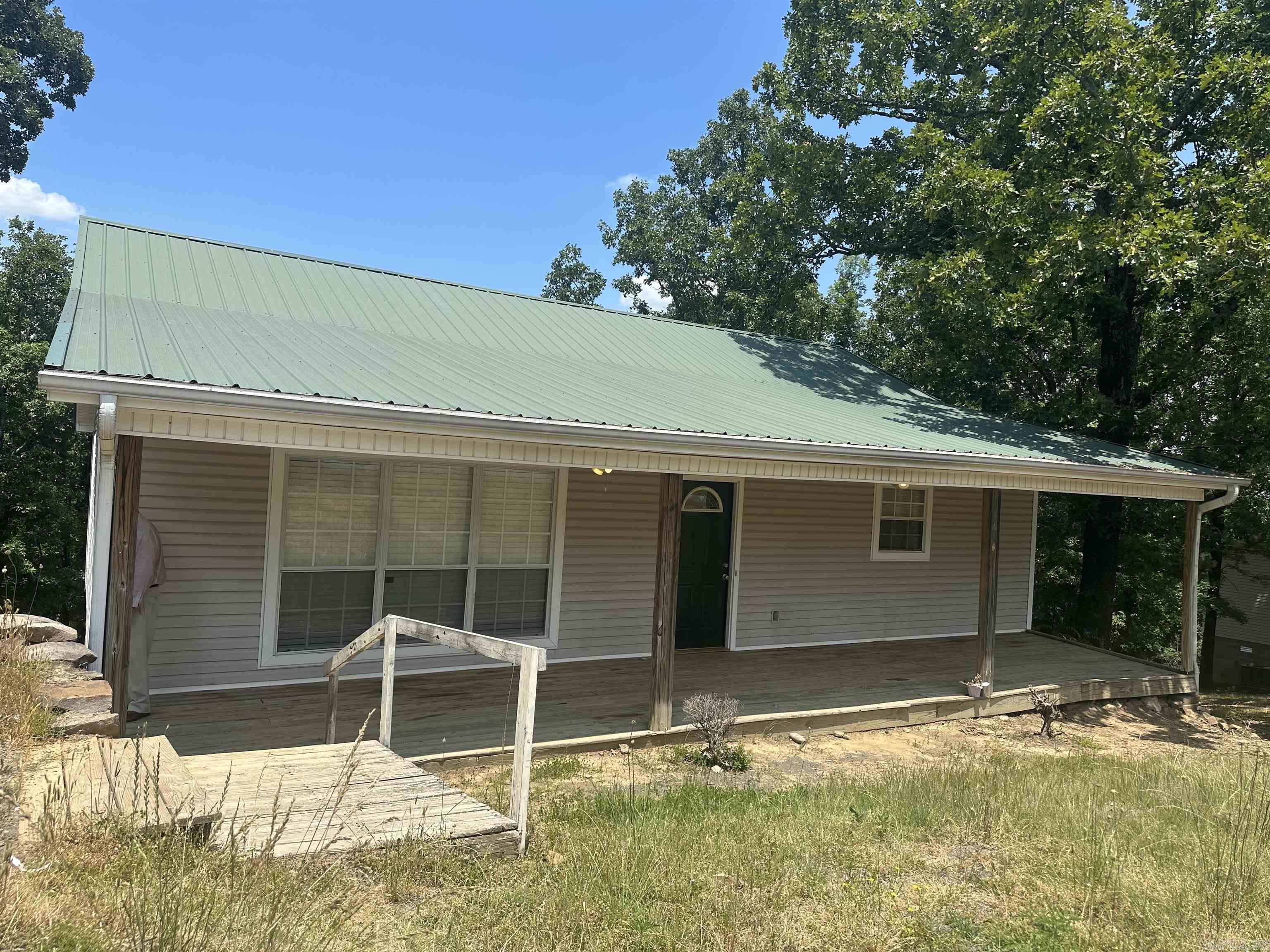 Great little starter home in the county but close to shopping, dining and highway access. Sits on almost half an acre with a metal roof and large inviting front porch. Don't miss it! Has been used for a rental property and is currently occupied but renters will vacate upon closing.