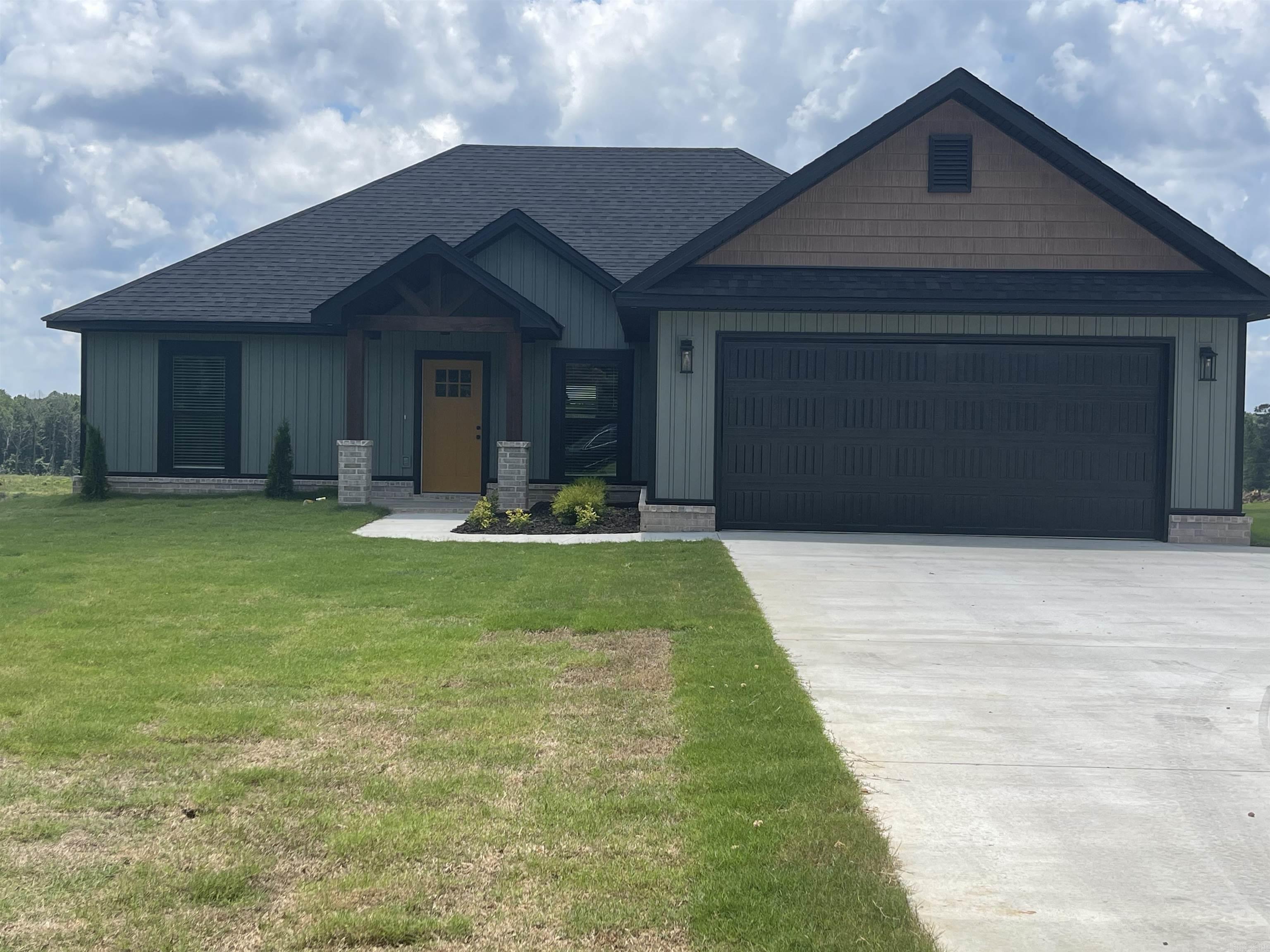 Great street appeal! Beautiful new construction home on flat one acre lot in Bauxite School District. Features large breakfast bar in kitchen, recessed electric fireplace with 50 inch TV above mantel in living area. Primary bathroom has double vanities, tiled walk in shower and large closet.