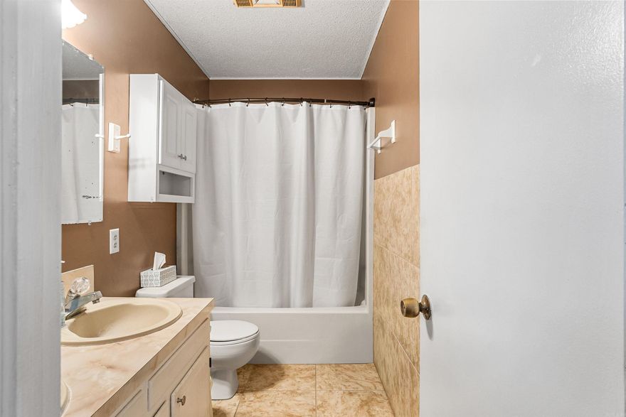 Well-maintained 3 bedroom, 2 bath home featuring a functional split floor plan on approximately 1.3 acres in a quiet setting just outside Cabot city limits. Home offers a large covered front porch, perfect for relaxing and enjoying the peaceful surroundings. Upon entry through the front door, you are welcomed into the foyer. To the left are two guest bedrooms and a full bath. To the right is the spacious living room featuring a wood-burning stove. The living room flows into the dining area and kitchen. The primary bedroom is located off the kitchen to the left, with the laundry room conveniently positioned to the right. Home includes a spacious 2-car garage. The back porch is half screened-in and half open, ideal for enjoying the outdoors. Large backyard is partially fenced along both sides and across the back. Enjoy a quiet country feel while still being just minutes from Cabot and convenient to shopping and amenities. **Professional Photos coming SOON!!