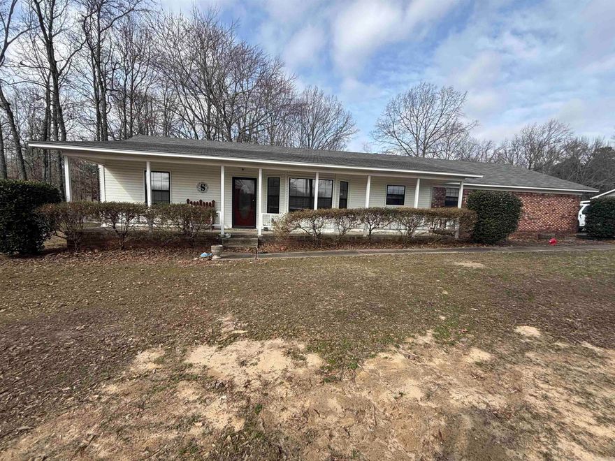 Well-maintained 3 bedroom, 2 bath home featuring a functional split floor plan on approximately 1.3 acres in a quiet setting just outside Cabot city limits. Home offers a large covered front porch, perfect for relaxing and enjoying the peaceful surroundings. Upon entry through the front door, you are welcomed into the foyer. To the left are two guest bedrooms and a full bath. To the right is the spacious living room featuring a wood-burning stove. The living room flows into the dining area and kitchen. The primary bedroom is located off the kitchen to the left, with the laundry room conveniently positioned to the right. Home includes a spacious 2-car garage. The back porch is half screened-in and half open, ideal for enjoying the outdoors. Large backyard is partially fenced along both sides and across the back. Enjoy a quiet country feel while still being just minutes from Cabot and convenient to shopping and amenities. **Professional Photos coming SOON!!