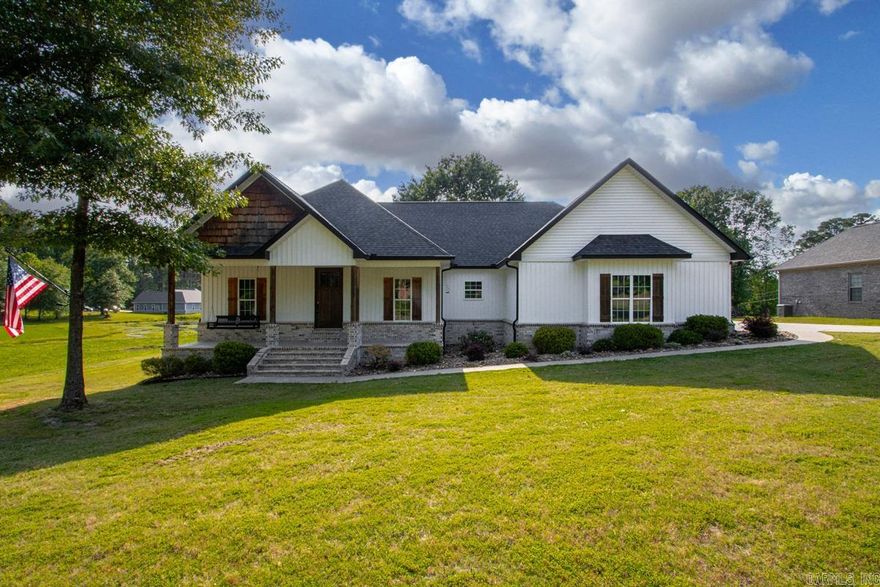 Tucked away in one of Sheridan’s most desirable areas near the country club, this stunning custom-built home is situated on nearly an acre and it has a shop! Built in 2021, this beautifully designed 5-bedroom, 3-bath home features over 2,400 sq ft living space with striking modern finishes and warm rustic touches throughout. Step inside to soaring vaulted wood ceilings, a dramatic floor-to-ceiling stone gas fireplace, rich lvp flooring, and an open-concept layout made for entertaining. The kitchen is a showstopper with custom cabinetry, granite countertops, gas range, large island with seating, and a spacious walk-in pantry. The split floor plan offers a private primary suite complete with a spa-like bath, soaking tub, tiled walk-in shower, double vanities, and an oversized walk-in closet. Enjoy the flexibility of multiple bedrooms perfect for family, or home office space. Two en-suites! Outside, you’ll love the peaceful setting, covered front and back porches, and spacious yard with room to relax or entertain. The oversized garage, beautiful curb appeal, and desirable location close to Sheridan Country Club make this property truly stand out. Sheridan Schools