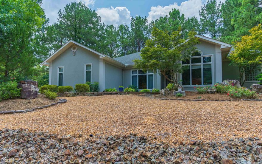 Welcome to this beautifully updated 4 bedroom, 2.5 bath home located on the popular East End of Hot Springs Village.  Step inside, and you'll immediately appreciate the warmth of the home's design.  Features include 13 foot ceilings; crown molding/trim; granite and stacked stone fireplace; preachers bar; and large windows that provide an abundance of natural light accenting the details of this lovely home.  One of the many highlights is the amazing gourmet kitchen with a six burner Thermador Professional Series stove with two ovens; Thermadoor stainless hood with heat lamps; and an abundance of beautiful cabinetry and granite countertops;  Other features include a spacious primary bedroom with ensuite bathroom that with a premium quality Finlandia sauna; separate laundry room; 3 car garage and covered and uncovered outdoor decks for outside enjoyment.  The home is built on a .53 acre corner lot with secluded back yard and coy pond in front that creates a peaceful and tranquil ambiance that's hard to come by.  Don't miss your chance to experience the serenity of this natural setting and the beauty of this well-appointed home. Agents see Remarks for additional details.