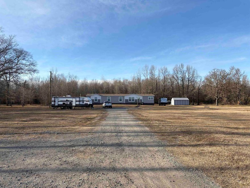 An extraordinary sweet home sitting outside of town on 5 acres, with RV hookups, a shop, lots and lots of area to play outside and run off into the tree covered parts. This home has all of the extra features that most of us forget to mention when talking about buying a home. There's two full sized living areas, an en-suite, 4 spacious bedrooms, big wide open kitchen and living area with a breakfast bar separating them. Will qualify for 30 year fixed rate loans, if you do!