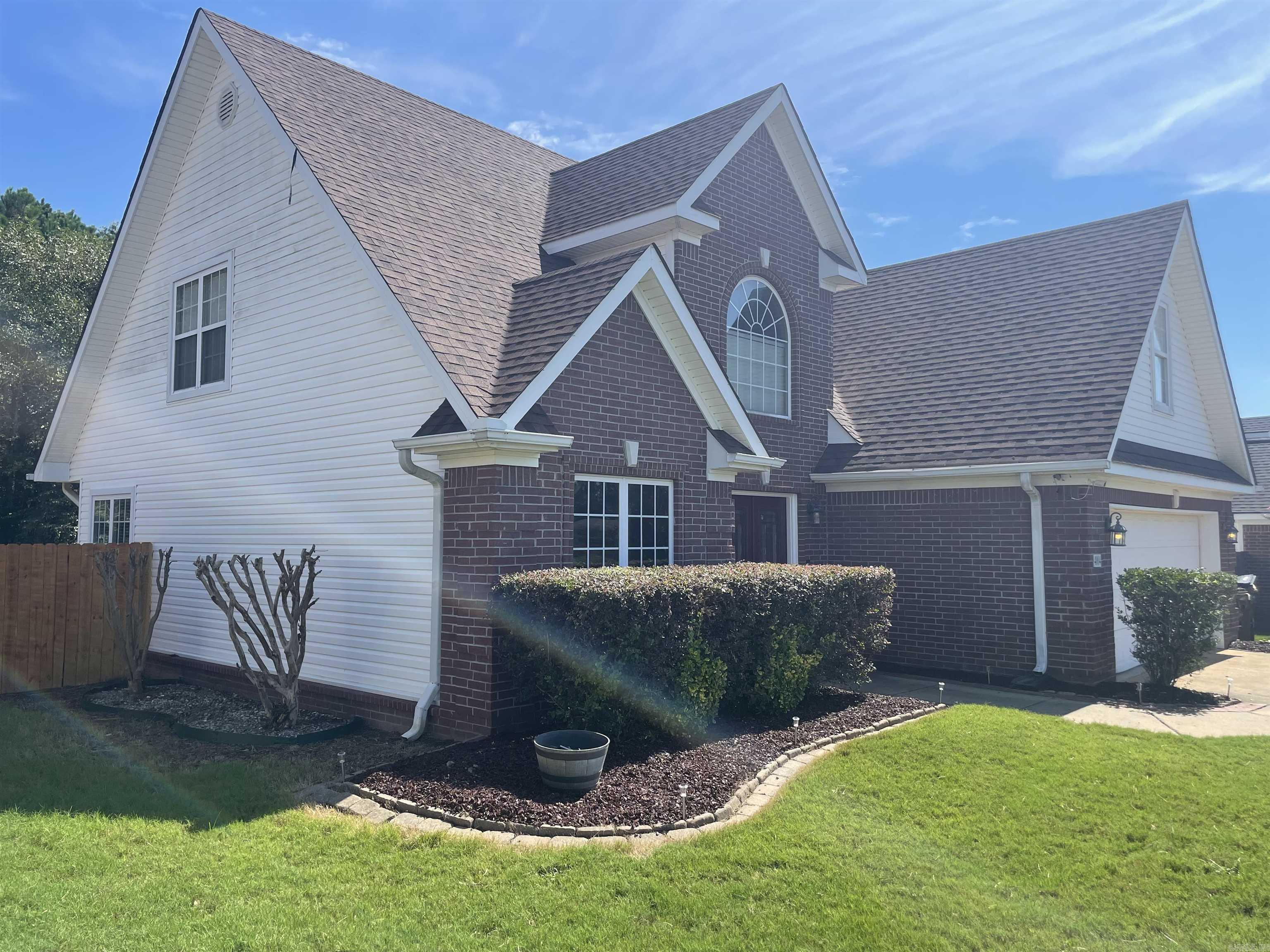 Take a look at this home in one of Saline County's most desirable neighborhoods!! Featuring a formal dining room, eat-in kitchen area, and a generous living room, this home has ideal spaces for entertaining. A see-through fireplace in the living room seamlessly connects the cozy living room with the outdoor living space. Enjoy the warmth and ambiance from both indoors and out---perfect for entertaining or relaxing year-round. The primary bedroom is on the main level and includes an en-suite bathroom with walk-in shower. The laundry room and an additional half bath are also located downstairs. As we continue up the beautiful staircase, you will find a wonderful railing overlooking the downstairs living area and a great little alcove for reading or an office area. You will also find three generous bedrooms, an additional full bathroom and a LAUNDRY CHUTE!! Let's head on out to the backyard where you will find a gorgeous covered patio which includes that see-through fireplace. Huge back yard with new fencing (Lifetime warranty thru Lowe's) Roof replaced 8/2025, AC replaced 2 years ago, Water Heater 2024.....ALL THIS HOUSE NEEDS IS YOU!!!!