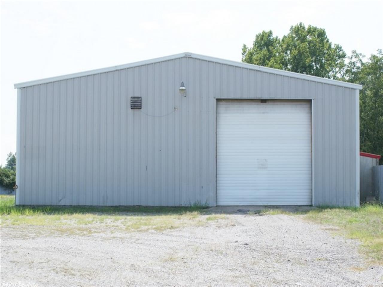 Nice 3750 sq. ft. building in a high traffic area. Ideal property for garage, car lot, and shop building. Shop and Office space with 1.58AC compacted graveled yard. Building contains 1 office, rest room with shower, and direct access to the shop area. Concrete floor in the shop with a 3X36 pit to go underneath vehicle to work, 7hp 60 gal two stage working air compressor, and 3 large 14' ft overhead doors with drive thru. Great buy, owner taking a loss.