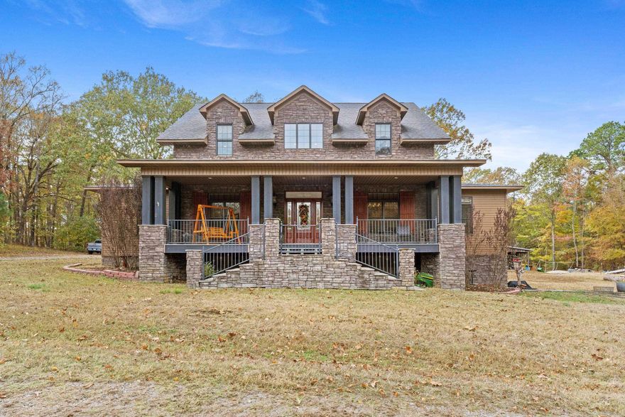 An Aspen-inspired retreat right here in Arkansas, this custom-built home offers over 5,000 square feet of beautifully designed spaces. Step inside & you’re welcomed by warm wood floors & an impressive soaring ceiling. The main kitchen has tons of natural sunlight, ample cabinetry, two sinks, large prep areas, & a butler’s pantry.  The primary suite is on the main level and features a personal coffee bar which sets the tone for quiet mornings. The spa-like primary bathroom flows into a private porch—great for unwinding with a book or enjoying fresh air.  The upper level has two oversized suites. One has a total of 5 closets!  One of the standout features is the walk-out basement: a fully separate living quarters that could be its own home. It has a spacious living room, full kitchen, bedroom, office, & a large bathroom. Outside, the property continues to impress. The detached garage has stairs that lead to oversized storage area. The barn has over 1,200 square feet of enclosed storage plus two overhang areas. Plumbing is already conveniently installed! Come see it!