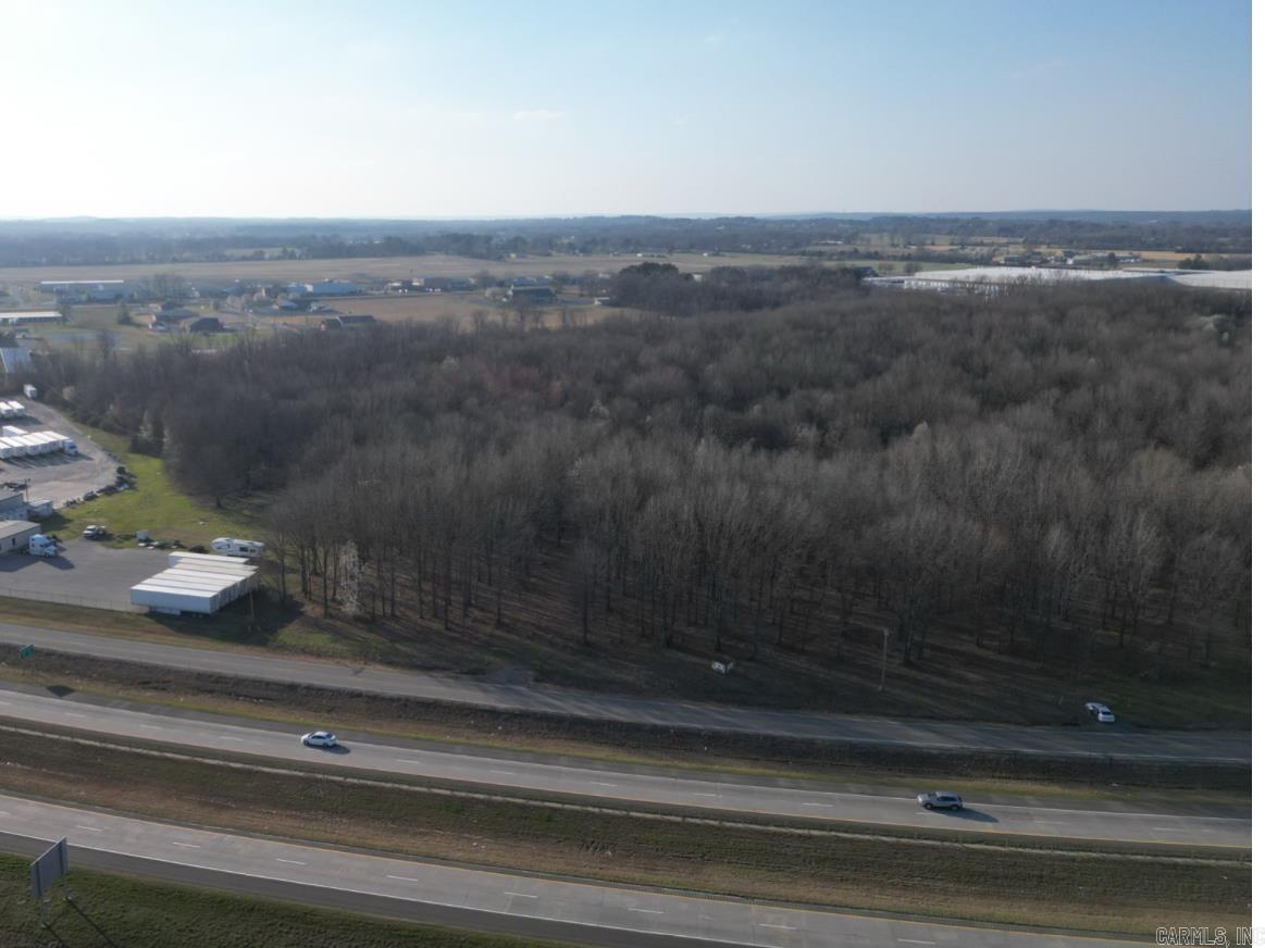52+- Commercial, Residential, Industrial acres located on Quality Road next to Highway 267 in Searcy City Limits. One of the largest tract left in Searcy City Limits with HIghway frontage. The city has designated land set aside along the north border of this property to be used for connecting Quality road to Booth road if needed. Mature Hardwoods dominate this property offering excellent Bow Hunts if desired. Highest and best use of property is Light Industrial, RV, Boat Storage, Commercial, Apartment Complex, Trucking operations. The Property has Wal Mart Distribution on the North end of property and a trucking company located on the South End. High visibilty and large traffic counts per ARDOT website (greater than 3600 vehicles per day). Prime Commercial property like this does not stay on the market very long.