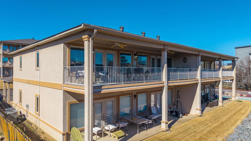 Welcome to Unit C-4 at Waters Edge Condominiums, a light-filled corner residence offering an elevated lake lifestyle and income potential. High ceilings, a well-appointed kitchen, and an open floorplan offer a high-style, airy feel upon entry. Both the living area and primary suite open effortlessly to an expansive covered balcony--with a view--spanning the width of the condo. The kitchen and baths are finished with stone countertops, custom tile work, and generous storage, making this condo equally suited for full-time living, entertaining, or short-term rental use--which is permitted and offers strong income potential. Located in the popular 7-South corridor, you are just minutes from dining, shopping, and Hot Springs attractions. Waters Edge features gated entry, a beautiful pool, optional boat tie-ups, and two dedicated covered parking spaces—a rare and valuable convenience for lakefront condo ownership. With exterior maintenance handled by the association, Unit C-4 presents a low-maintenance opportunity as a refined lakefront getaway, second home, or investment property designed for flexibility and ease.