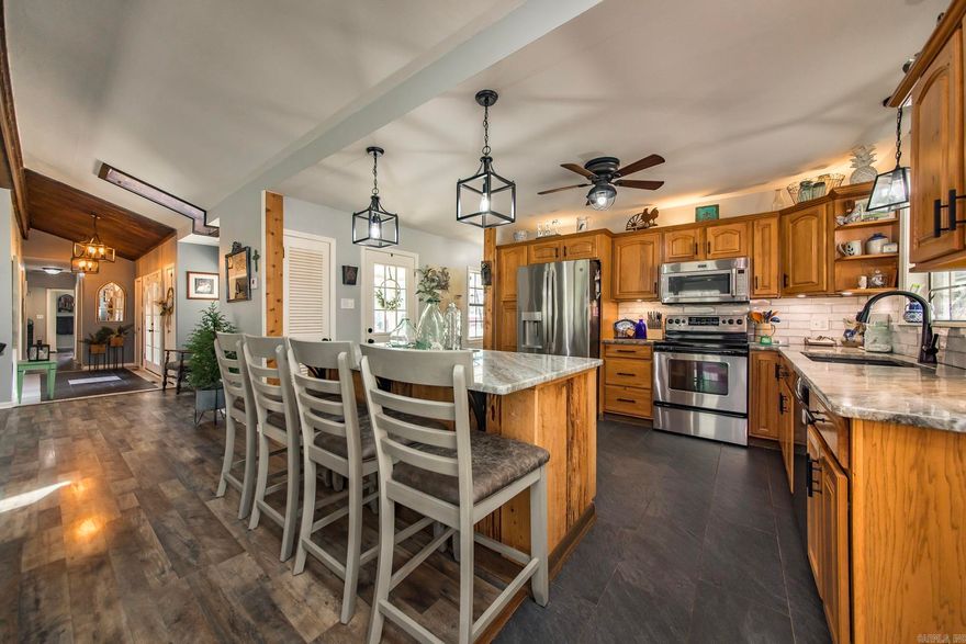 Discover the perfect blend of privacy, comfort, and modern updates with this 3-bedroom, 2.5-bath, single-story home set on over 7 tranquil acres. Located just 30 minutes from Little Rock and only 2.5 miles from Tar Camp Park along the Arkansas River, this property offers both convenience and a peaceful retreat. This spacious 1-story home offers an updated kitchen featuring quartz countertops, a granite sink, custom oak cabinets, a stylish new backsplash, updated fixtures, and under-cabinet lighting, newer refrigerator (2024) and dishwasher (2024). Other improvements include updated bathrooms, a newer HVAC system, and a water heater (2024), Two fireplaces, and Pecky Cypress Entrance. Outside, the property truly shines with a newly built 38x60 barn (2024), gutters with leaf guards, and a dedicated RV pad with electrical hookup—perfect for storage, hobbies, etc. The expansive acreage provides endless opportunity to enjoy nature or recreation.