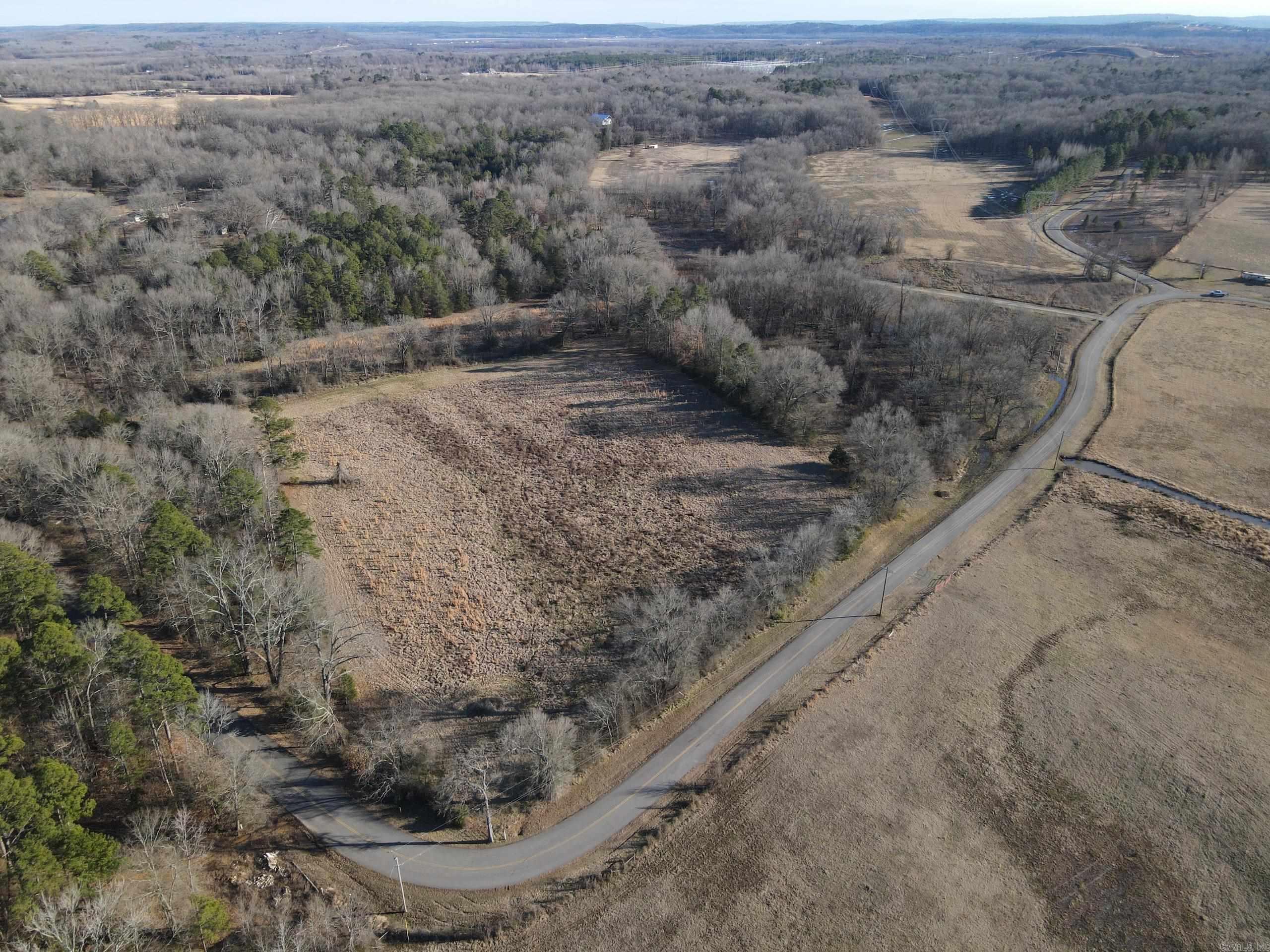 This unique property boasts paved road frontage on two sides and is conveniently located just over a quarter mile from Mayflower High School. A gated entrance ensures privacy and easy access. While much of the property is in the floodplain, approximately one acre along the road is buildable, making it an excellent site for a home or other development. The land features a blend of improved pasture and timber, with the remainder in unimproved pasture, offering versatility for agricultural or recreational use. Utilities, including electricity, water, and internet, are available along the road, and the property is partially fenced. Minerals owned by the seller will convey, adding further value to this offering. Whether youāre looking for a buildable homesite, agricultural potential, or a mix of both, this property provides a range of opportunities in a convenient location.