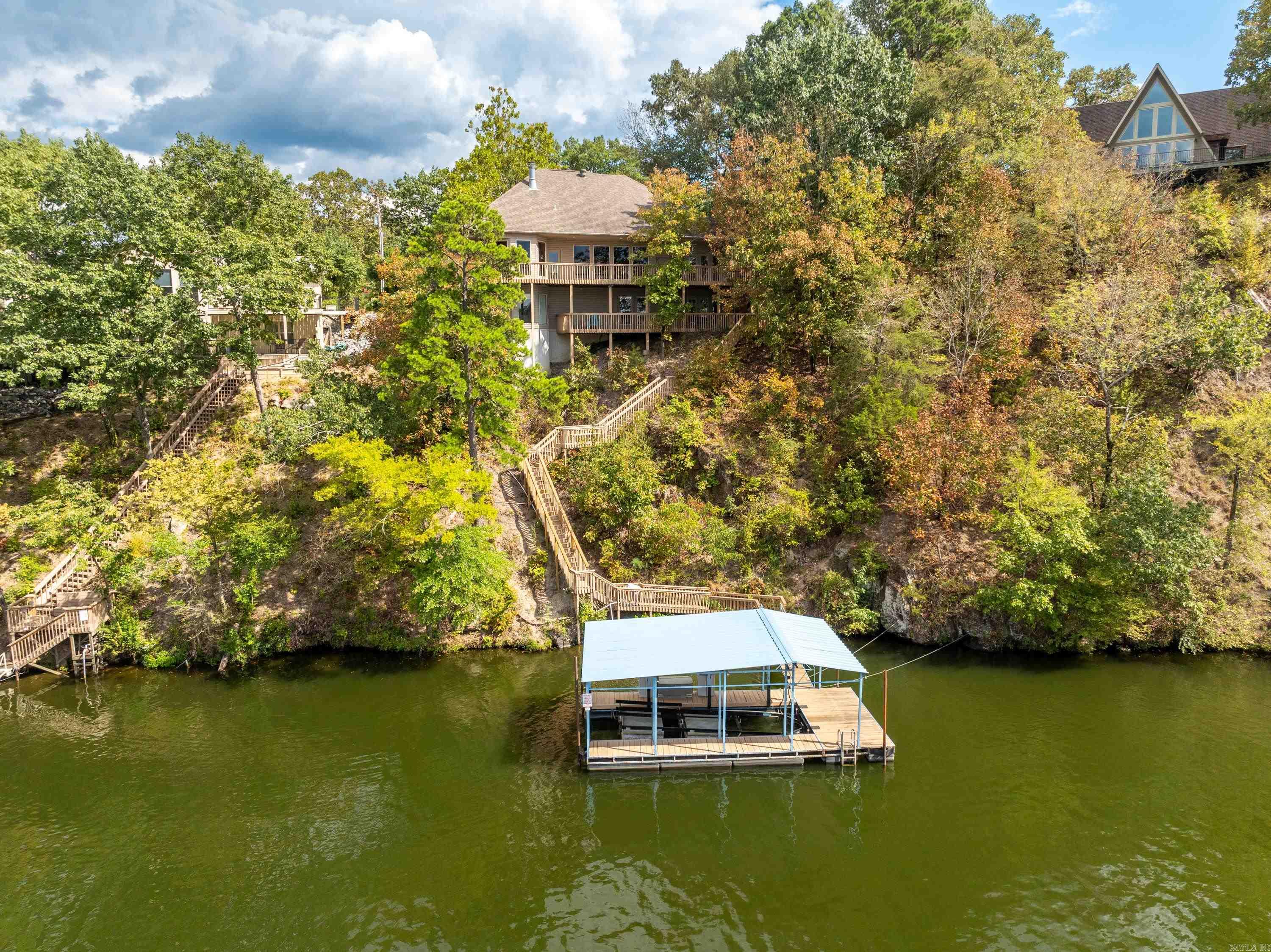 Located in the Diamondhead Community this custom waterfront home has outstanding lake and mountain views. Main level has master suite, office, living room, dining room, kitchen, breakfast nook, pantry, utility room & half bath. Kitchen has custom oak cabinets, granite counter tops, double ovens & pantry. Gas log fireplace. Full width deck on main level overlooking Lake Catherine and the homes own boat dock with lift. Lower level with 3 bedrooms, one and one half baths, bonus room with pool table. Refrigerator, pool table & treadmill convey. Generac Generator. Buried propane tank. Leaf filters on gutters. 2018 Chaparral 21 deluxe boat is negotiable. Area amenities include an 18 Hole PGA sanctioned golf course, clubhouse with restaurant, banquet room, workout facility, Olympic size swimming pool, and tennis/pickleball courts. Please visit diamondheadcommunity.com