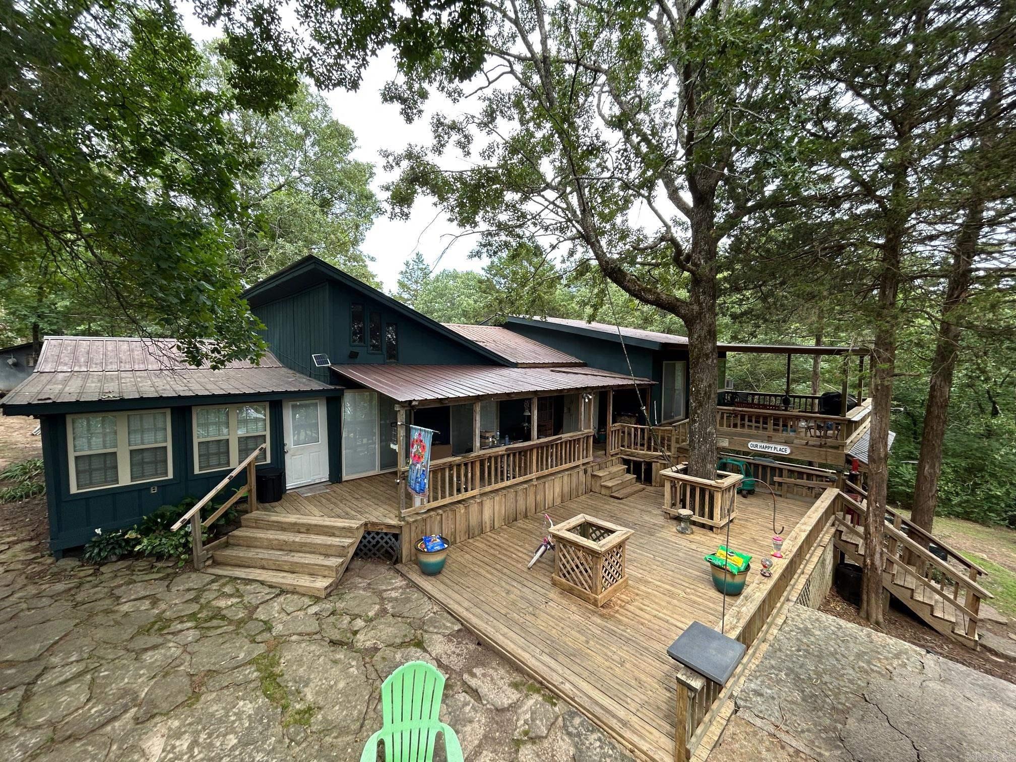 If you are looking for a getaway this is it!!!! Unique property, house on lake with 2 extra lots and a shared 2-slip boat dock. This property is perfect for a lake getaway for large family or a full time residence with mother in law quarters! Priced to sell!!!!