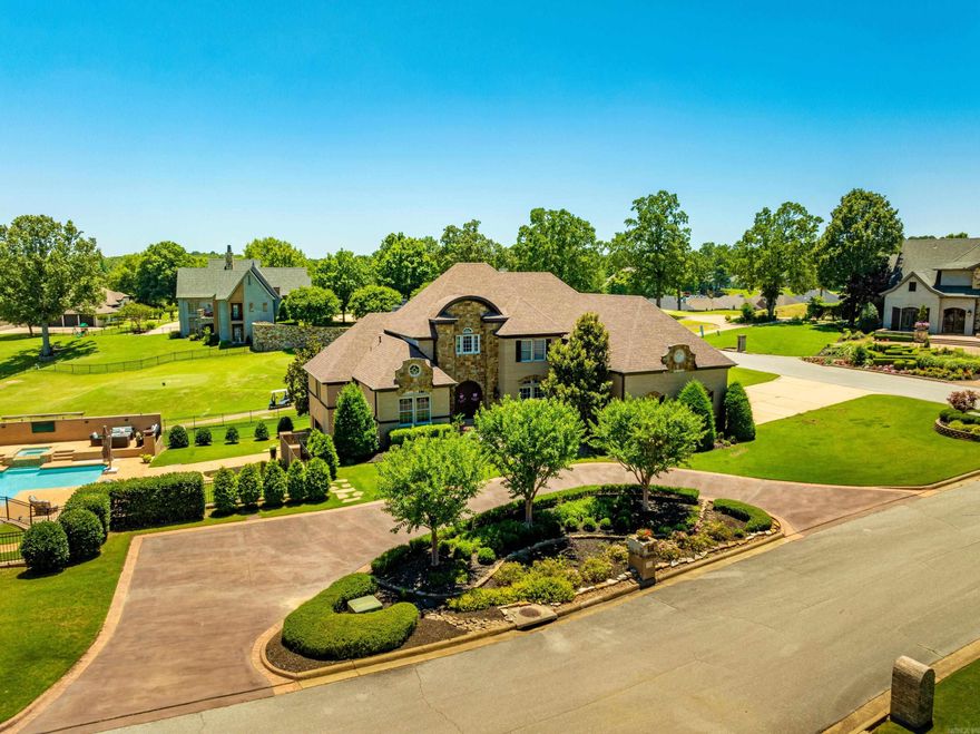 Luxury Living on the Golf Course – RidgePointe Country Club, Jonesboro, AR  This stunning 5-bed, 5.5-bath estate offers 7,990± sq ft under roof and overlooks the 7th hole at RidgePointe Country Club. Located on a corner lot, this home has it all—private saltwater pool, hot tub, sport court, and an indoor/outdoor kitchen with roll-up doors perfect for entertaining.  Inside, you’ll find a chef’s kitchen with gas cooktop, Miele coffee system, and double ovens, elegant marble floors, sunroom with golf views, and a luxurious primary suite with spa bath and walk-through shower. Upstairs includes 3 more bedrooms, 2 baths, and a second laundry. The walk-out basement features 2 theater rooms, game space, full bath, utility room, and a grilling area that opens to the backyard oasis.  Extras include a 3-car garage, circle drive, and $20K painting allowance. Located just minutes from everything Jonesboro offers and part of a prestigious golf community. Seller is owner.