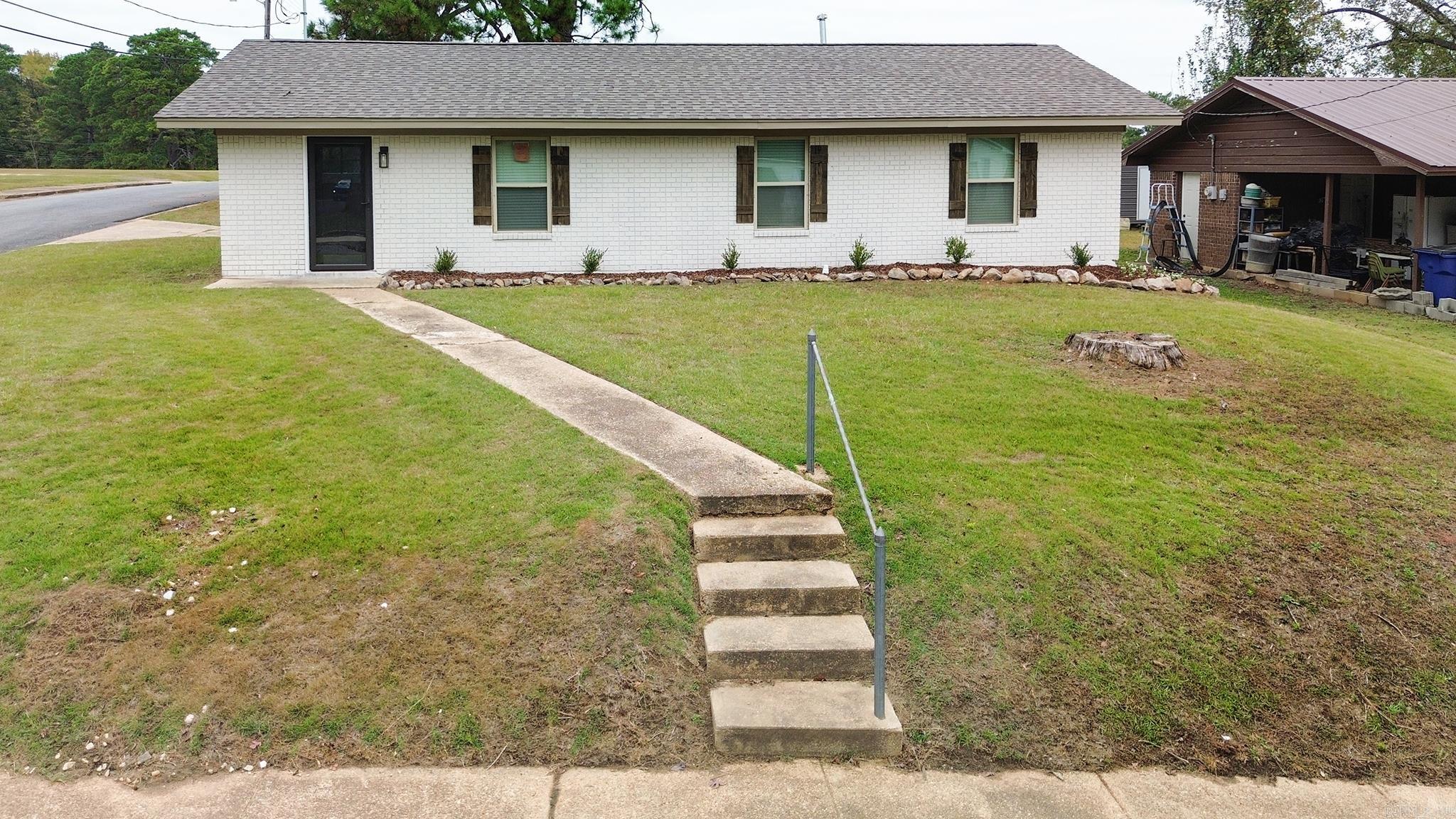 Welcome to this modern and completely renovated residence with upgrades that will take your breath away at first sight!! This home boast 1,140 sq ft of living space; features three bedrooms, two full bathrooms, and located on a spacious corner lot. This modern gem offers premier location with easy access to downtown Camden, 79S, local restaurants, shopping, schools, and so much more.   Step inside and you are greeted by a modern and inviting family room that's connected to the dining area. The family room and all bedrooms come with luxury vinyl plank and black fixtures. The kitchen, adorned with marble tile, sleek quartz countertops, black cabinetry, and stainless-steel appliances. Bathrooms are decorated with marble tiled floors and tiled bathtubs. Step outside to a covered carport, and ideal space for outdoor entertainment and relaxation. Don't miss out on the opportunity to make this beautiful modern home your own! Schedule your showing today and take the first step towards owning this property at 130 Center Street, Camden, Arkansas 71701.  *Reference Agent Remarks*