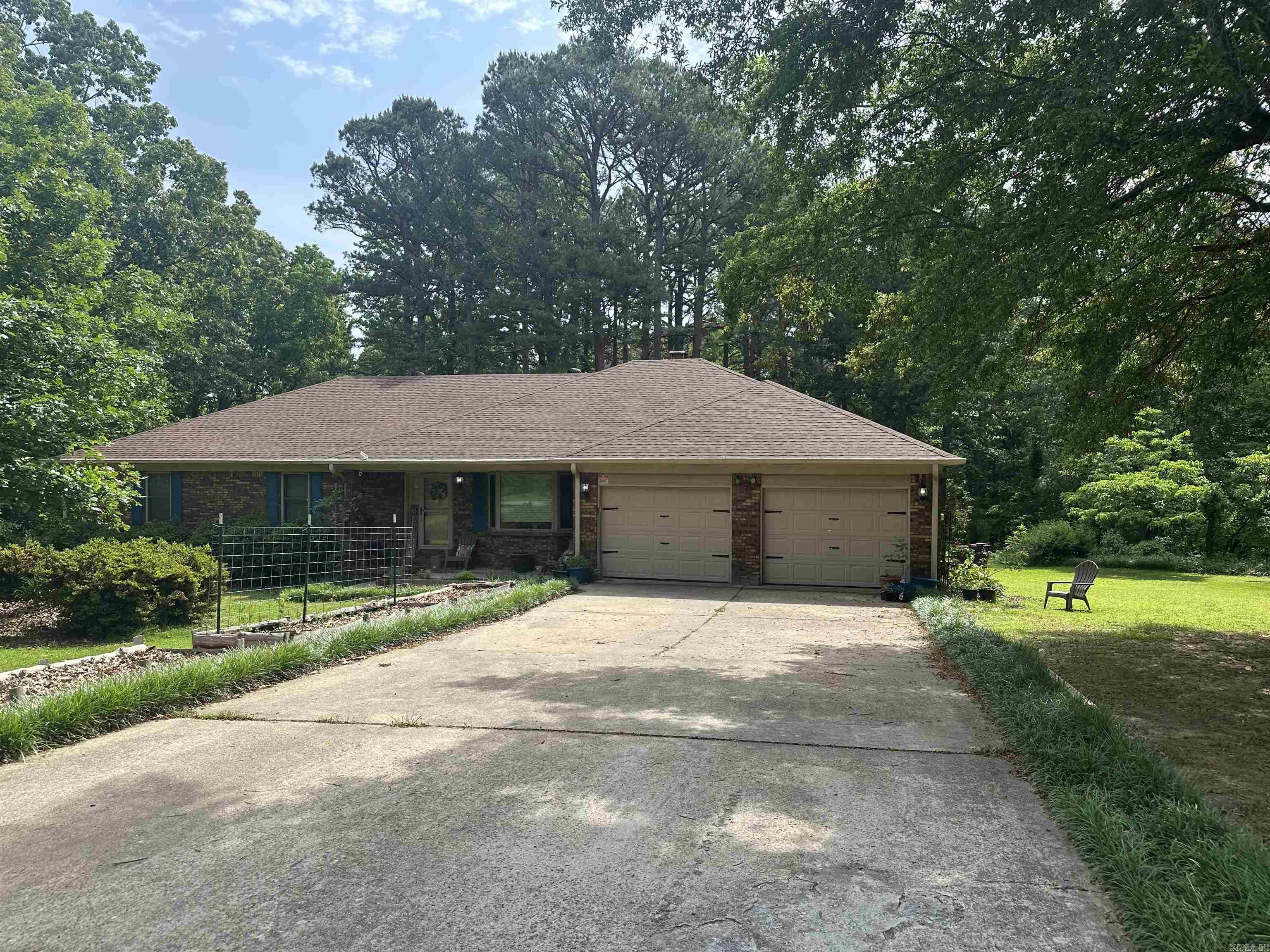 Country living in the city limits on a quiet, dead end street. If that sounds perfect look at this 3-bedroom, 2-bath home sitting on 2.5 acres of mostly wooded land, with a huge shop and all the privacy you could possible want. The kitchen is complete with granite countertops and a breakfast bar. The living room is sunken, has skylights and a wood burning fireplace. Three good sized bedrooms with ample closet space. The primary bedroom has double doors that walk out to the covered back porch that is a wonderful place to enjoy your morning coffee or afternoon sweet tea! The roof was replace in 2022 and HVAC in 2024. SEE AGENT REMARKS