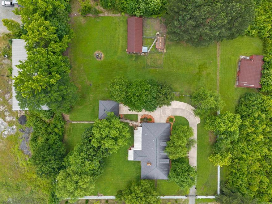 Designed for flexibility, function, and everyday comfort, this thoughtfully maintained single-level home offers a rare blend of space, privacy, and versatility—both indoors and out.  Inside, the home features 4 bedrooms and 3 full bathrooms, complemented by multiple living and working spaces that adapt effortlessly to today’s lifestyles. A dedicated home office setup, formal living and dining areas, and generous common spaces create a layout that works just as well for daily living as it does for hosting guests.  The farmhouse-inspired kitchen serves as the heart of the home, remodeled with timeless finishes including an apron-front sink, granite countertops, expanded cabinetry, pantry storage, and updated appliances—designed for practicality.  Step outside to a setting that truly sets this property apart. The large fenced yard is ready for animals, hobbies, and outdoor living, complete with a barn and chicken coop already in place. A spacious workshop with 220-amp service, 30-amp RV hookup, and storage adds incredible utility rarely found at this price point. Easy access to Hwy 65, making this location especially well-suited for business use while being close to home.