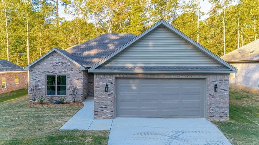 Welcome home to this stunning new construction! This beautifully designed 3-bedroom, 2-bath residence offers a perfect blend of comfort, functionality, & modern style. The inviting entryway opens into a spacious living room accented by a charming brick fireplace, creating the perfect spot to relax or entertain. The open-concept layout flows seamlessly into the chef’s kitchen, featuring gorgeous granite countertops, abundant cabinetry, ample workspace, & a generous pantry. Durable LVP flooring runs throughout the main living areas & bedrooms, with tile in all wet areas for easy maintenance. The spacious primary suite offers a serene retreat with a luxurious en suite bath showcasing double vanities, a walk-in tile shower, & a relaxing soaking tub. The oversized primary closet includes a built-in safe room for added peace of mind. Two additional bedrooms share a full bath with double vanities, providing plenty of space for family/guests. Step outside to enjoy the level backyard & covered patio — ideal for morning coffee or evening gatherings. Conveniently located near shops, dining, & major travel routes, this beautiful home truly has it all. Don’t miss your chance to make it yours!