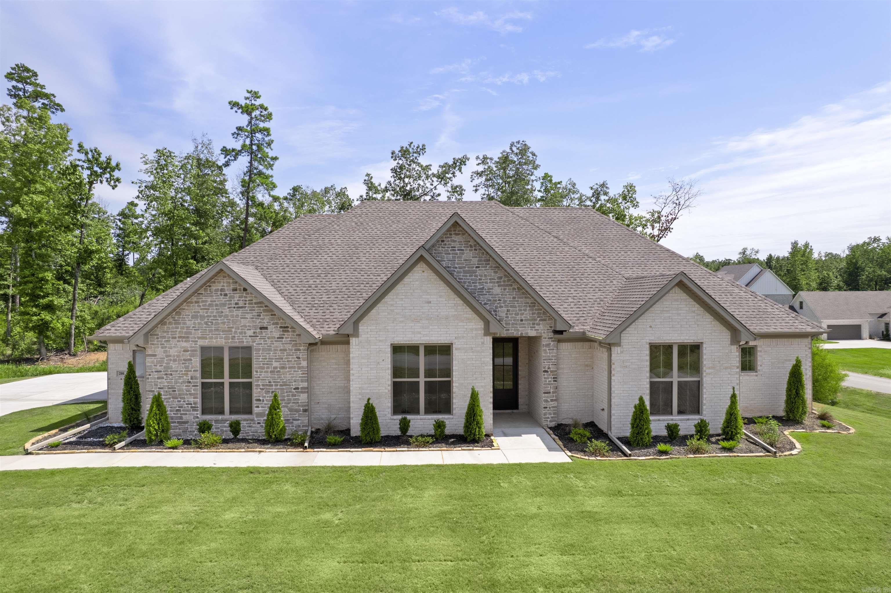 $10,000 in CLOSING COSTS PAID WITH ACCEPTABLE OFFER. This exclusive gated community in the highly sought-after Avilla community in Bryant School District offer a perfect blend of luxury and comfort. This stunning new home features four spacious bedrooms, three full baths and a three-car garage, designed with both elegance and functionality in mind. This home high-end finish outs that set it apart. Rich hardwood floors flow throughout the main areas, adding warmth and elegance. Custom cabinets and quartz tops enhance the kitchen and baths with a sleek modern touch. The stunning trim package elevates the homes design in all the right places to showcase the expert craftmanship. Every detail has been carefully considered to create this inviting atmosphere to truly make it stand out. Agents see remarks.