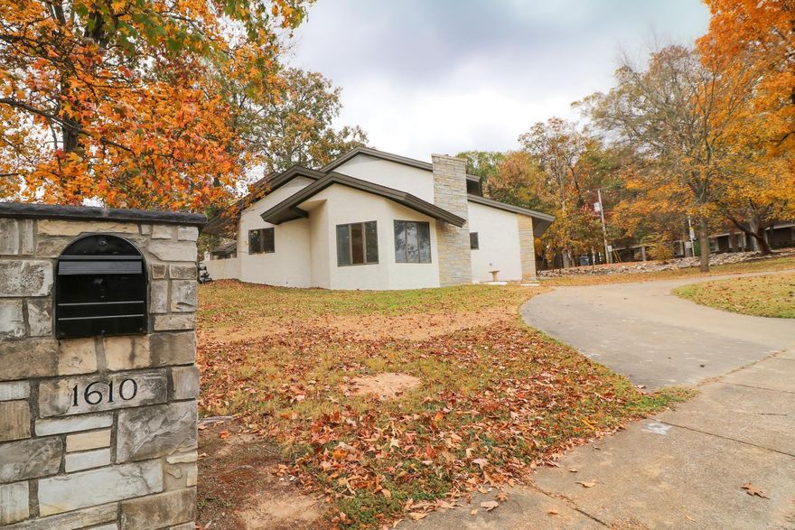 Welcome home to 1610 Metzler.  Located in the heart of Jonesboro near Jonesboro Country Club and McArthur Jr High School, this stunning mid century modern home has been recently improved to include a wide array of new modern finishes that compliment this timeless design. The floor plan is a one of a kind layout with a fully remodeled kitchen, formal dining room, office with wet bar, a very spacious master suite and an attached double garage. Upstairs includes 2 large bedrooms, a Jack-N-Jill bathroom with private sinks and toilet areas and a den/2nd living room.  Some of the many amenities include a fireplace in the living room, a front and rear patio area, a large free standing soaker tub and separate shower in the master bath and so much more.