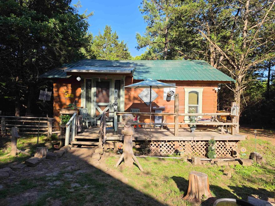 This property is a homesteader’s dream, incredible investment opportunity, or the perfect place to enjoy peaceful country living with room to grow. Situated on five beautiful acres near Wooley Hollow State Park and just minutes from Persimmon Ridge Disc Golf Course, this unique property offers privacy, recreation, and endless possibilities. The main cabin features approximately 784 sq ft with a one-bedroom studio layout, full kitchen, spacious living area, full bathroom, Samsung washer and dryer, and loft space for storage or additional sleeping. A large barn includes an additional apartment with one bedroom, full kitchen, full bath, and living area. Apartment square footage is unknown and not included in the listed square footage. Downstairs offers extra storage plus an additional room with electric and water already in place. The acreage includes cleared land ideal for gardening, livestock, or hobby farming, along with wooded ATV and walking trails. An additional metal barn with electric and water provides even more versatility. Don’t forget to pay your respects to “Old Boo,” the family dog who still watches over this amazing property.