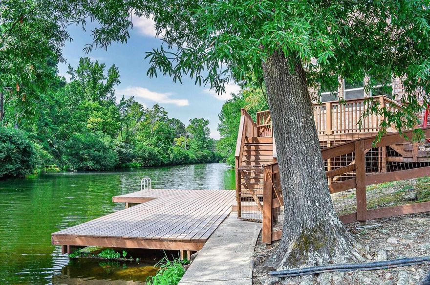 Beautiful lake front home on Lake Hamilton. This custom home has so much to offer! Beautiful hardwood vaulted ceiling in the living room and kitchen. Many interior walls are brick.  Wood floors in 3 bedrooms. Large island in the kitchen for easy entertaining. Bosch appliances. Granite counters. Split bedrooms. 3 bedrooms within the main house, one private bedroom and bath with access from the deck. Kitchen, Dining, Living room and baths have tile floors. Lake front boasts a swim dock with ladder. Oversized 2 car garage. This home is currently an Airb&b. There are two boat stalls that would have to be purchased separately and would be required to purchase with the sale. The two stalls would be $10,000 each and sold outside of a real estate contract. AGENTS SEE REMARKS
