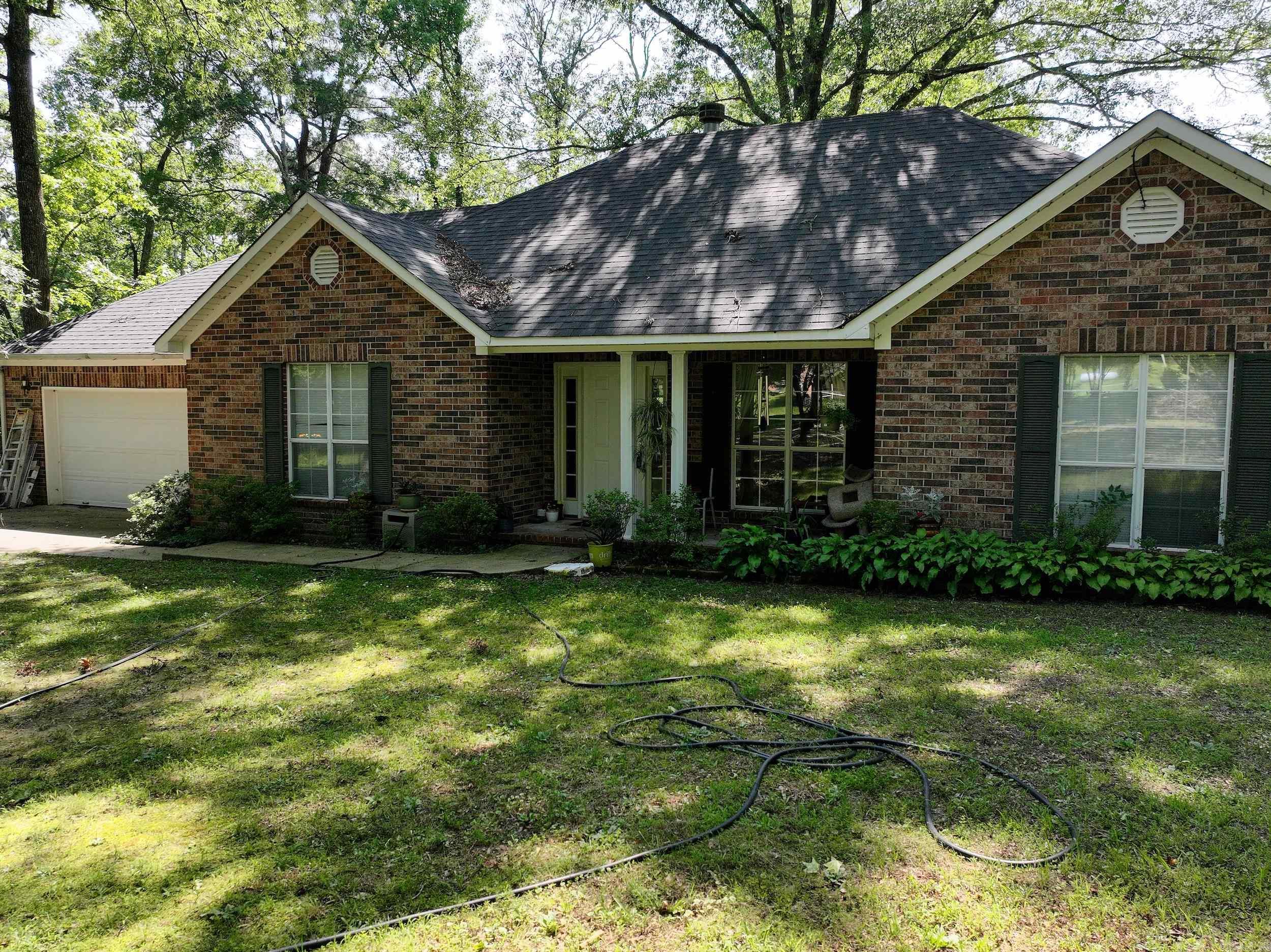 This inviting residence features three bedrooms and two bathrooms. Situated on a sprawling 17.5 acre parcel bordered by the tranquil Little Mazar Creek. Heating, hot water heater and cook stove are fueled by butane gas with the tank owned by the gas company for added convenience. The split floor plan ensures privacy and seclusion between sleeping quarters. The roof was replaced in November of 2023 enhancing the property's overall appeal. Offering a serene living space in a peaceful setting, this home is ideal for those seeking both comfort and natural beauty.