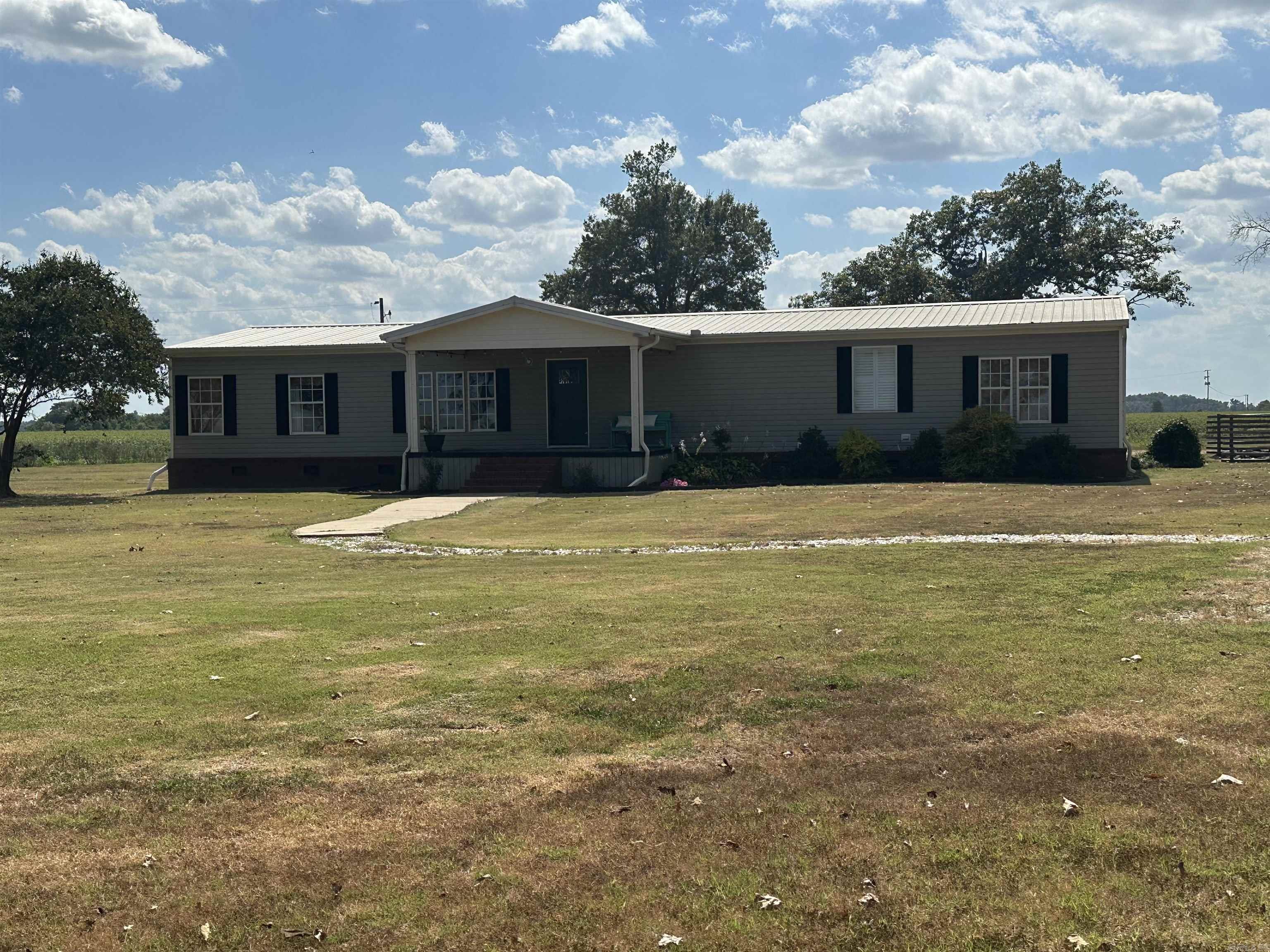 Country Living at Its Best Now on the market is this truly impressive custom-built home on 4 acres in Lincoln County! Designed with quality and comfort in mind, this home features: • Solid construction with Sheetrock walls, 2x6 stud walls, extra insulation, crown molding, and beautiful wood cabinetry. • Unique layout with a spacious curved hallway, 3 bedrooms, and 3 baths. • Functional spaces including a large laundry room, a huge walk-in closet, and a generous island kitchen. • Outdoor living with both front and back porches, plus 2 storage sheds for all your needs. This property offers the perfect blend of craftsmanship, character, and country charm. This home will now qualify for a no down payment RD loan. $189,000