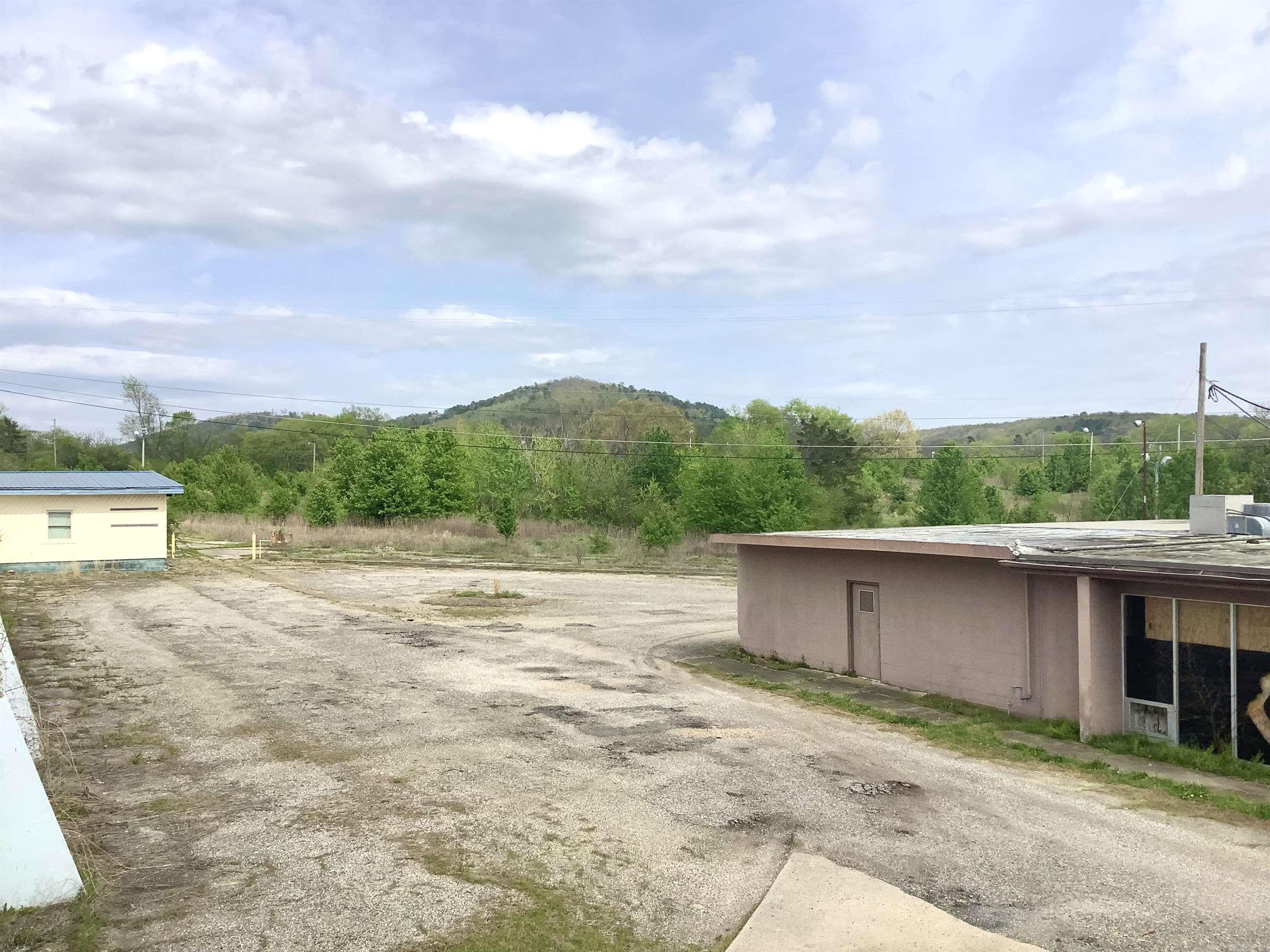 Commercial land development opportunity with high visibility, accessibility, and close proximity to some of the most well-known travel destinations in the South. This property includes 2 adjoining parcels: 1873 & 1875 E Grand Ave. for a total of 16.03 acres. Zoned C-R/C-4 "Regional Commercial." All utilities on site. Formerly Magic Hills Golf Course. Near Magic Springs Theme & Water Park. 492 ft of frontage. Could be suitable for Retail, Restaurant, Self-Storage, RV Park, Food Truck Park, Gas Station etc.