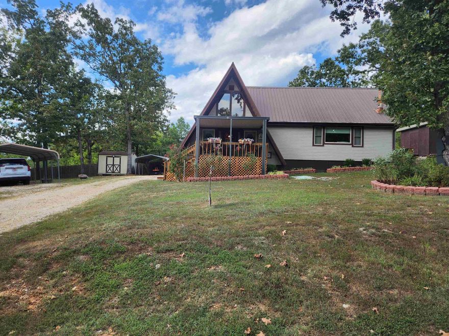 Super cute, very well-maintained Double, A-frame home with 4 bedrooms and 2 - 3/4 bathrooms. Nestled in the middle of 3 lots with lake views of Lake Mirandy. This home comes with 2 outbuildings for storage.  There are 2 covered parking areas, one for cars and one for lawn maintenance equipment. There is a water softener and a huge pantry/ laundry room just off the kitchen. This home could be a perfect Vacation home or used as a VRBO. This home is conveniently located with quick access to the 4-Lane but is also secluded enough to make you feel like you're living in the country. This home can be purchased fully furnished other than the guest room, with an acceptable offer. Make an appointment to see this cutie today.