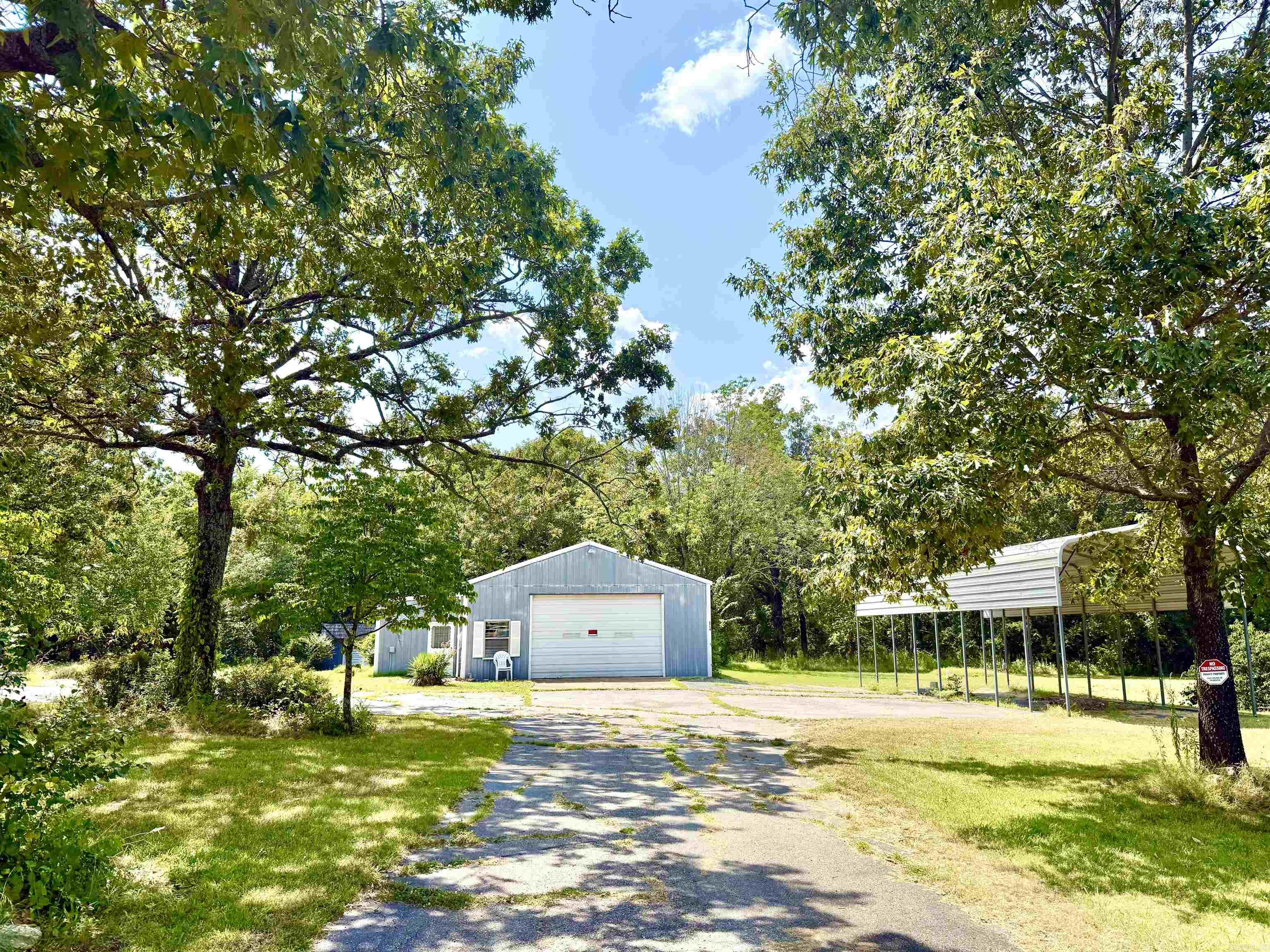 Commercial Shop w/ 4 (level) acres & Hwy 5 N and CR 11 Frontage!!! Excellent location for a business with a traffic count of 8,500 daily. 1,872 sq ft heated & insulated building. It has 11x11 office/reception with a 1/2 bath! Main part of building is 29 x 47 w/16' overhead door. Back of building has 10' sliding door and 10' roll up door, opening to a 11.5' x 15' room. Detached storage building is 16 x 24 w/ 16' roll up door, and also 19 x 24 lean-to covered storage area. RV Carport has 24 x 26 concrete pad & cover is 16 x 40 with 10' walls. MH City water, natural gas, and NEW SEPTIC in 2021. Paved drive and parking! The yard is spacious & beautiful with mature trees. Lovely options for building spots. The set-up is here to work, play & live!