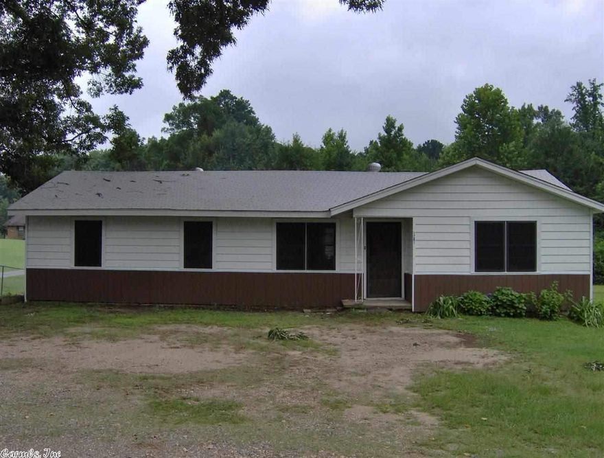 Two NEW bathrooms in this remodeled home. All new floors, laminate, tile and carpet in bedrooms. Six new ceiling fans to limit heat and air cost. New paint, electrical, and plumbing. Front half of roof was replaced, new siding, and new trim. There is a 20' X 20' storage building with slide up door and the property has  two and one third acres. Hard to find at this price.