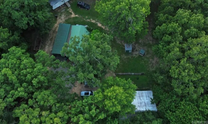 PRIVACY IN THE WOODS This home is being sold with 2.5 acres that offers 50' of frontage on Cadron Creek just down the hill. Offering ultimate privacy with a site-built home, RV spot and a 24x36' shop with covered Lean-to.  The property has 2 wells, Petit Jean Electricity, Fiber Internet and propane for a secondary heater and a propane stove top.