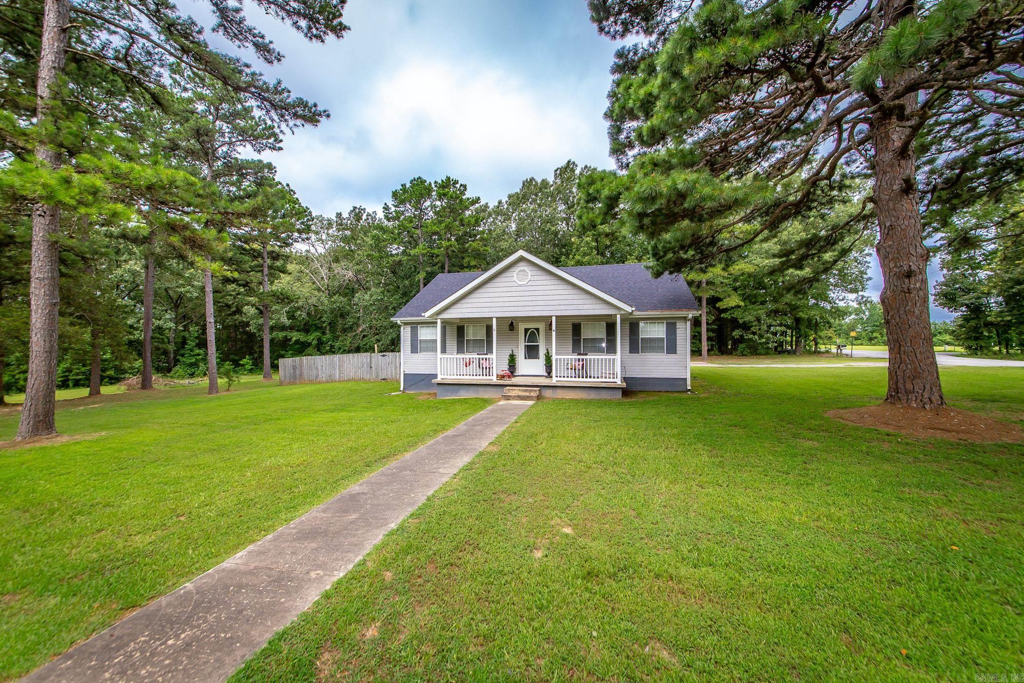 Two Lots located on the corner of South Dr. & Trace Dr. and only 1 mile to Shiloh Marina. The 4th bonus bedroom is located through the garage w/window unit (not included in the 1308 sqft). The rest of the home has central heat & air. Since Seller has owned it, she had new Architectural Shingled Roof replaced in 2023, new flooring installed, new paint, new light fixtures, & granite countertops installed. The garage space is setup for full size vehicle on one side & golf cart/sxs parking in the other bay where the 4th bedroom has been enclosed. Plenty of space on extra lot for someone that wants a detached garage for their lake toys. Fenced in backyard with covered back deck & outside storage building.