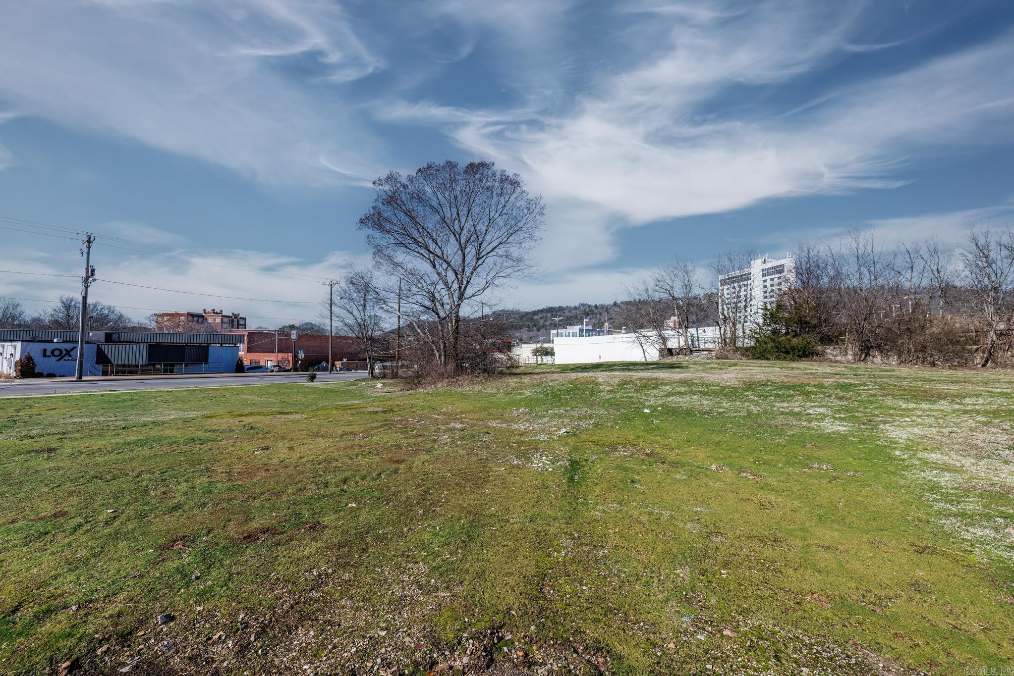 This buildable corner lot in downtown Hot Springs, Arkansas is perfect for commercial development. Situated on over one acre of land, the lot is strategically located on the corner of Malvern Ave and Gulpha Street, just one block away from the popular Hot Springs Convention Center. With its high visibility and heavy foot traffic, this property offers a prime commercial location. It is conveniently located just a few blocks away from the historic Bathhouse Row, adding to its appeal and potential for success. The lot is zoned as C-1, making it highly sought after for various commercial purposes. Permitted uses for this property include, but are not limited to, restaurants, spas, retail shops, and office spaces. The possibilities are endless, allowing entrepreneurs and investors to put their own creative spin on the property and cater to the diverse needs of the downtown area. Whether you're looking to establish a new business or expand an existing one, this buildable lot provides an exceptional opportunity to tap into the thriving downtown market of Hot Springs, Arkansas. Don't miss out on the chance to be a part of this vibrant and historic community.