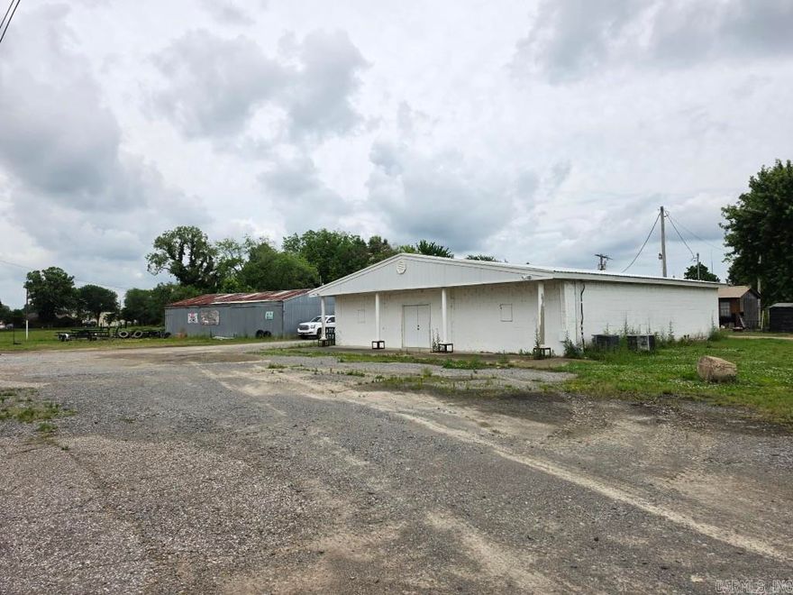 Commercial property with lots of potential and possibilities. There are 4 structures on the property. One was formerly used as a church, one was an auto repair shop, one was a wrecker service, and one is a living quarters.