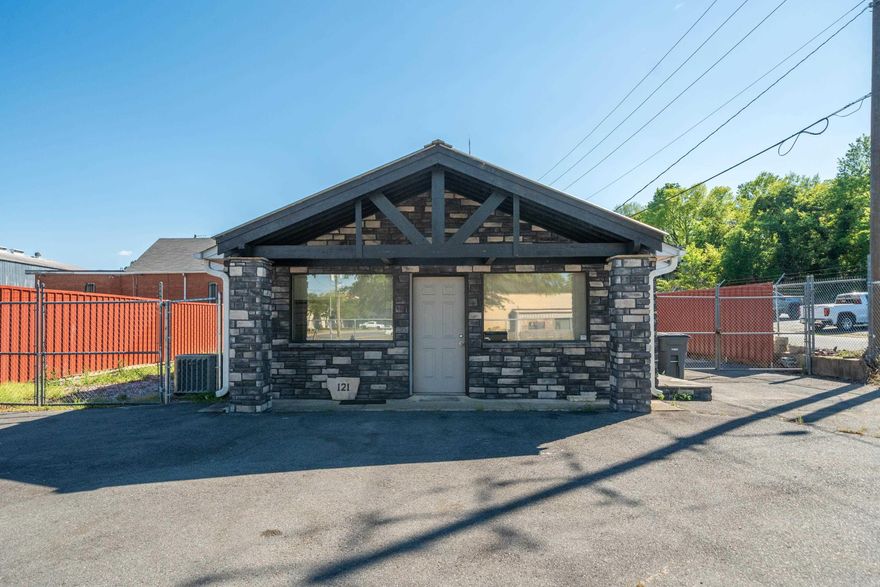 Commercial building on a fully fenced lot with high exposure right on the corner of West Grand Ave and Cherry Street. This property has great potential! The building has a wide open floor plan with 2 bathrooms, an extra sink area, closet & storage room. There are doublewide doors on the side of the building allowing large shipments in and out and an office area in front. Come see for yourself how you can make this property work for you!