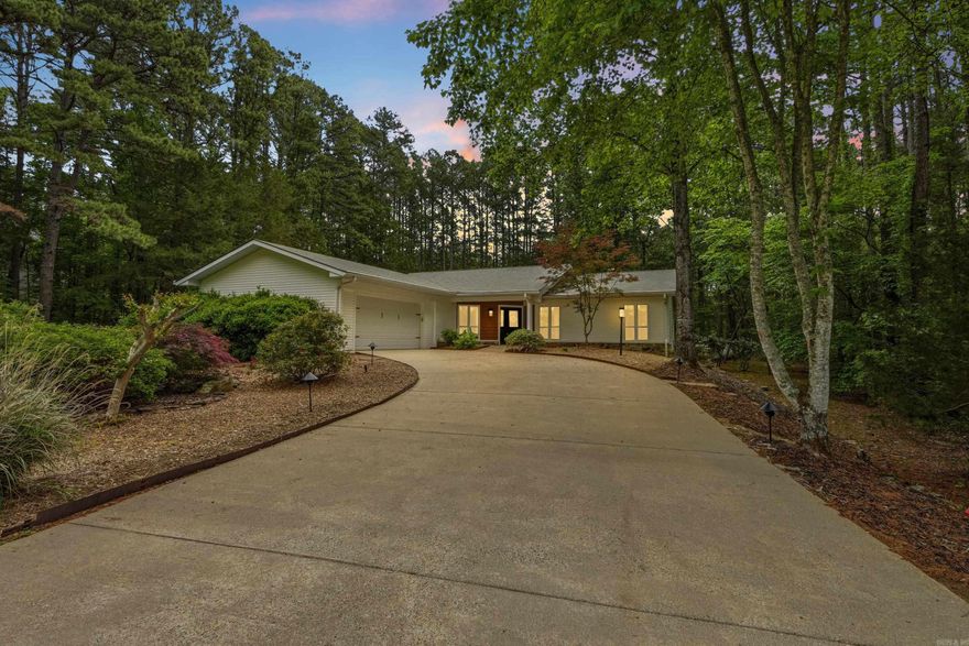 Great one-level home ideally surround by Mountain Ranch golf course on a quiet, peaceful street. This beautifully maintained property features new windows, newer flooring throughout, and stunning quartz countertops in the kitchen, primary bath, and laundry area. The spacious primary suite offers a large walk-in shower and elegant coffered ceilings, also featured in the living and dining areas. Enjoy year-round comfort in the enclosed heated and cooled sunroom overlooking the beautifully landscaped backyard, or unwind on the deck with cable railing—perfect for relaxing or entertaining. The home includes a large garage with extra storage, a generous walk-in pantry, and a well-designed laundry space with abundant storage throughout. Cozy evenings await by the stone fireplace with gas logs and blowers. Located just 5 minutes from Mountain Ranch Clubhouse and 10 minutes to Greers Ferry Lake, this home also gives you access to the incredible Fairfield Bay lifestyle—featuring 3 swimming pools, scenic hiking and biking trails, ATV trails, pickleball courts, tennis, bowling, miniature golf, and two 18-hole golf courses. Virtually staged. See agent remarks.