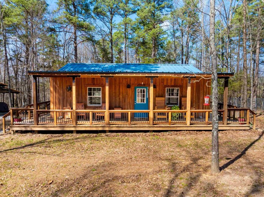 This incredible 40+/- acre property in Fox, Arkansas offers 3 cabins, large shop, carports, outdoor cooking pavilion, waterfall, creek, and prime hunting—all in one private Ozark setting. The main cabin (newly built in 2022) features approx. 884 sq ft with wrap-around porch, granite countertops, hickory cabinets, and custom wood finishes. The guest cabin (fully remodeled in 2025) offers 1 bed, 1 bath, kitchenette, and mini-split. A third vintage hunting cabin includes electric, outdoor shower house, and outhouse. Additional features include a 30x54 shop with 3-phase power, fiber internet, LED lighting, and office, plus cook shack, carports, storage containers, and trails leading to a spring-fed creek with waterfall and approx. ½ mile of creek frontage. Loaded with whitetail deer, turkey, and occasional black bear, this is a true hunting property with deer stand in place. Utilities: Entergy electric, West Stone County water, Yelcot fiber, Morgan Sanitation. Located less than 1 mile on gravel, approx. 30 minutes to Mountain View, 35 to Clinton, 40 to Greers Ferry Lake, 1 hour to Buffalo River. A rare opportunity for a private retreat, family getaway, or investment property.