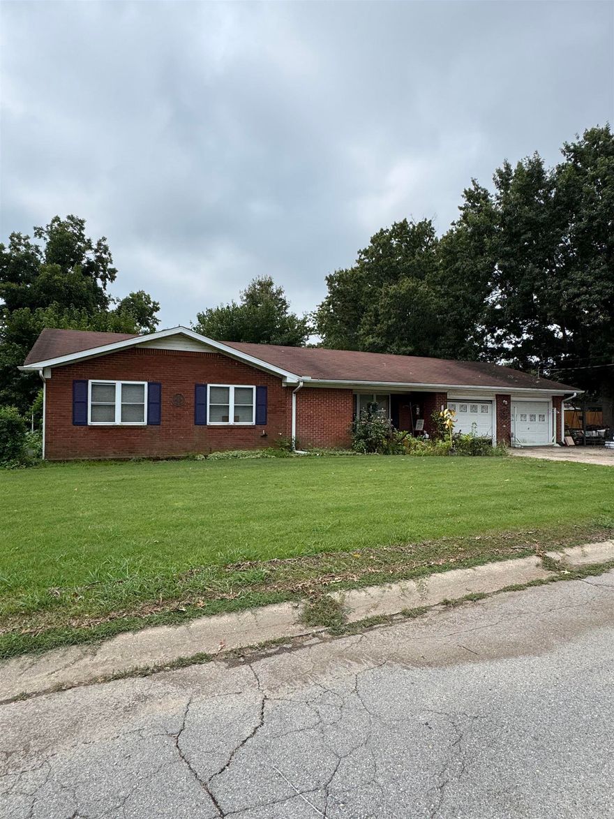 This brick home offers 3 bedrooms and 2 bathrooms. Eat in kitchen, living room and bonus room. Fenced in backyard. 2 lots and 20 x 30 shop building with a walk through door and a sliding drive thru door and a small storage shed.