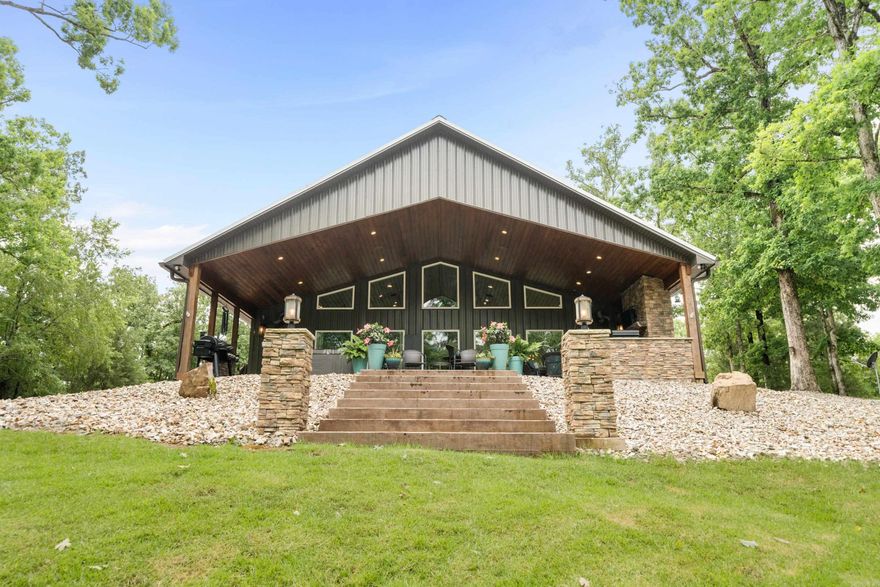 Welcome to your lakeside oasis! Nestled on a serene 3-acre lot, this beautiful lake house offers the perfect blend of luxury, comfort, and breathtaking natural beauty. Step onto the expansive 16x40ft patio living area and immerse yourself in peace. Whether you're unwinding in the bubbling hot tub or cozying up by the fireplace, this outdoor space is an entertainer's dream and a sanctuary for relaxation. Inside, the charm continues with a double-sided fireplace gracing both the spacious living room and the elegant primary room. Enjoy the warmth and ambiance on cool evenings as you relax in this inviting retreat. the most captivating feature of this property is the stunning views that greet you from every angle. Whether you're enjoying your morning coffee on the patio or lounging in the primary room, panoramic views of the shimmering lake and lush surroundings never fail to inspire. For water enthusiasts, this home comes with a covered boat dock, complete with two lifts and a convenient swim deck. After spending your days boating, fishing, or simply soaking up the sun on Lake Hamilton. A concrete patio area by the boat dock welcomes you home to a perfect spot for lakeside gatherings.