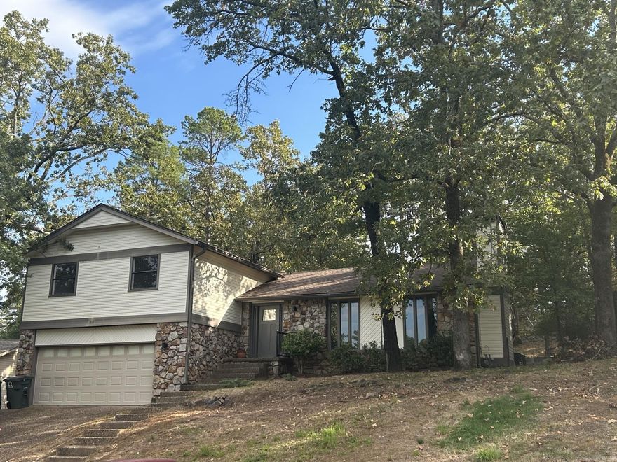 Beautiful split-level home in Marlowe Manor, a well-established West Little Rock neighborhood with a POA, park, and pool.  This 3-bed, 3-bath home features a spacious living room with ceiling beams and a gas fireplace, flowing into a stylish kitchen and dining area with French doors to the patio. Upstairs offers a private primary suite, two additional bedrooms, and a guest bath. The lower level includes a 2-car garage, laundry closet, and a flexible bonus room with an open full bath setup. Thoughtfully updated throughout with modern finishes, this home blends classic charm with contemporary comfort in a quiet, tree-lined setting.