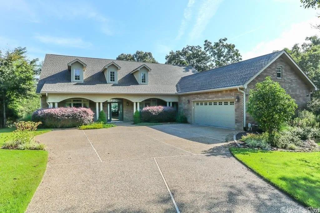 .4 acre premium point lot maximized lake view & privacy. Exceptional, classic architecture w/ 2X6 exterior construction, one level, 3 zone heat pump, volume ceilings, divided bedrooms, private large office, Arkansas room, great room w/ fireplace, huge kitchen w/ walk-in AND Butler pantry, granite, vaulted ceilings, crown molding, wood floors, fenced backyard, double boat dock, flagstone patio, 9X12 workshop in heated/ cooled garage. Front porch. SEE AGENT REMARKS. Contact agent for list of upgrades and amenities!