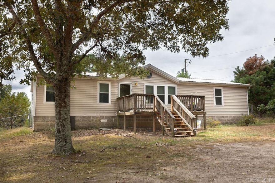 Discover tranquility at 4812 Bauxite Cutoff Rd. This 3BR, 2BA mobile home on 3.22 acres offers plenty of space to enjoy yourself. Large living room, private master suite, and covered patio await. Outside, a detached shop complements the expansive outdoor space. Embrace rural living with city amenities just a short drive away.