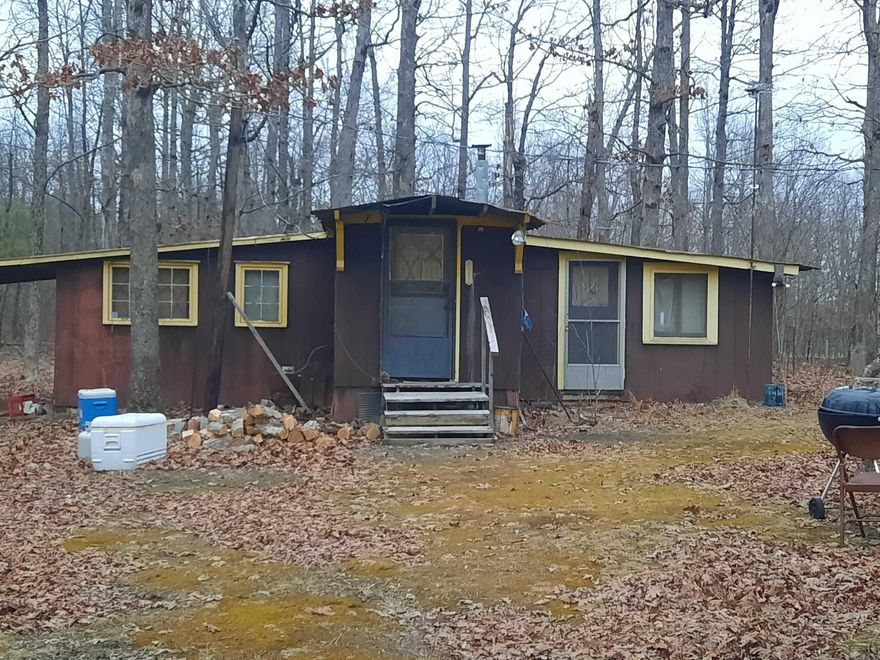 Looking for an affordable get-away, here is your opportunity.  A fixer upper cabin, in a beautiful rural setting, on a very nice tree shaded 1 acre.  You can sit on your porch and watch the deer, turkey and possibly an occasional bear. Give me a call and let me show you this serene retreat.